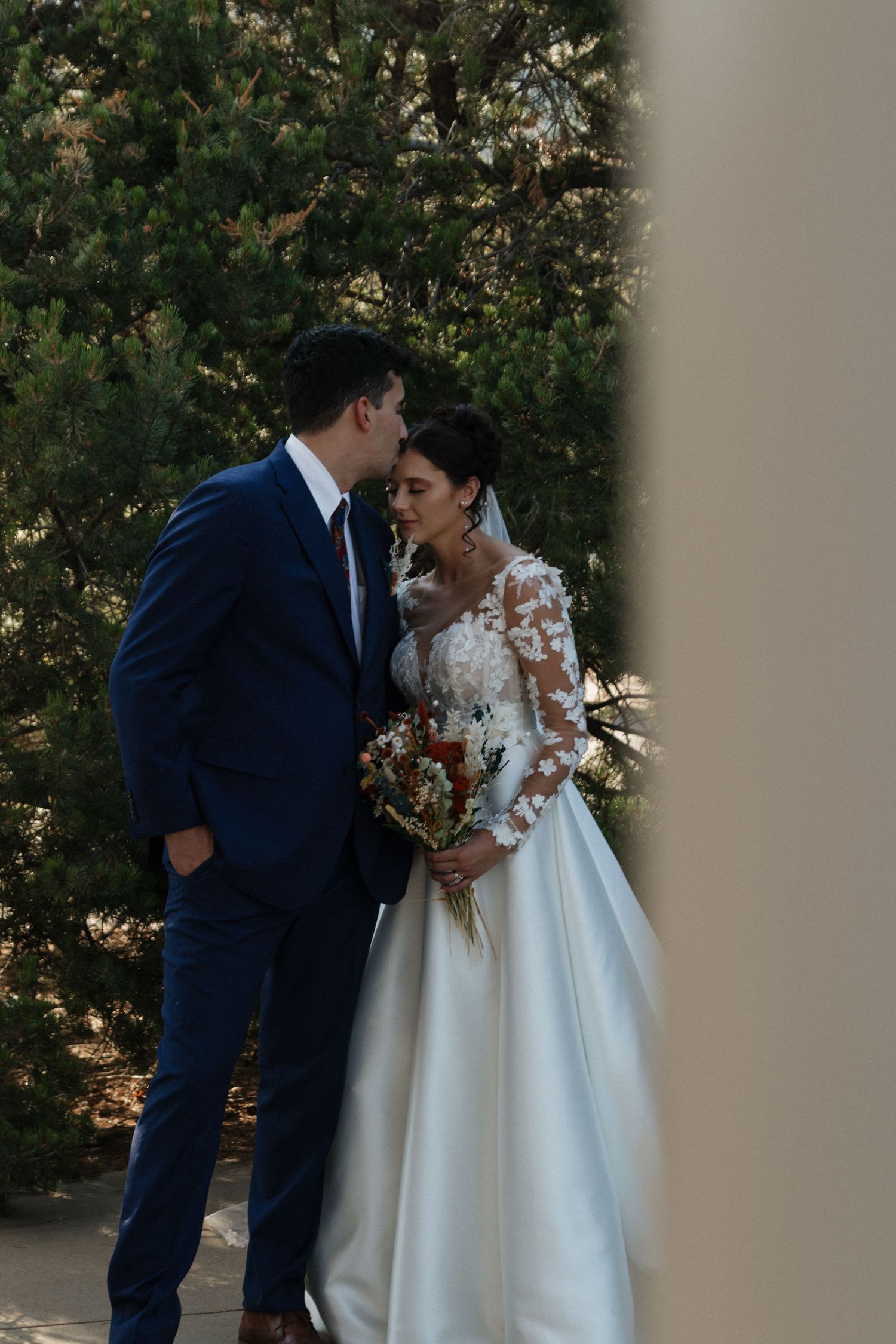 Romantic wedding portrait in outdoor garden setting.