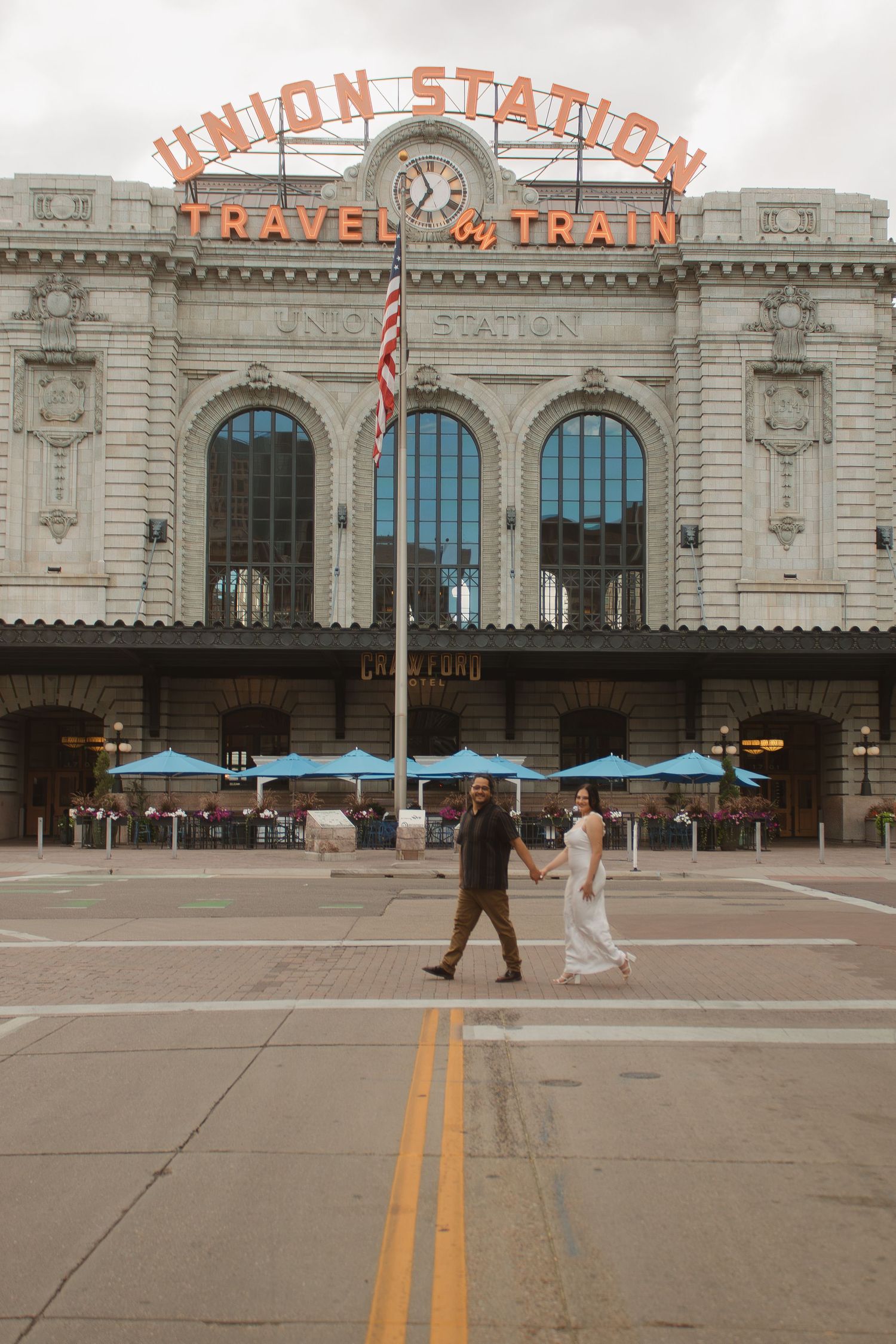 Multiple angles of Denver's historic Union Station exterior facade with blue umbrellas on its plaza in overcast weather.