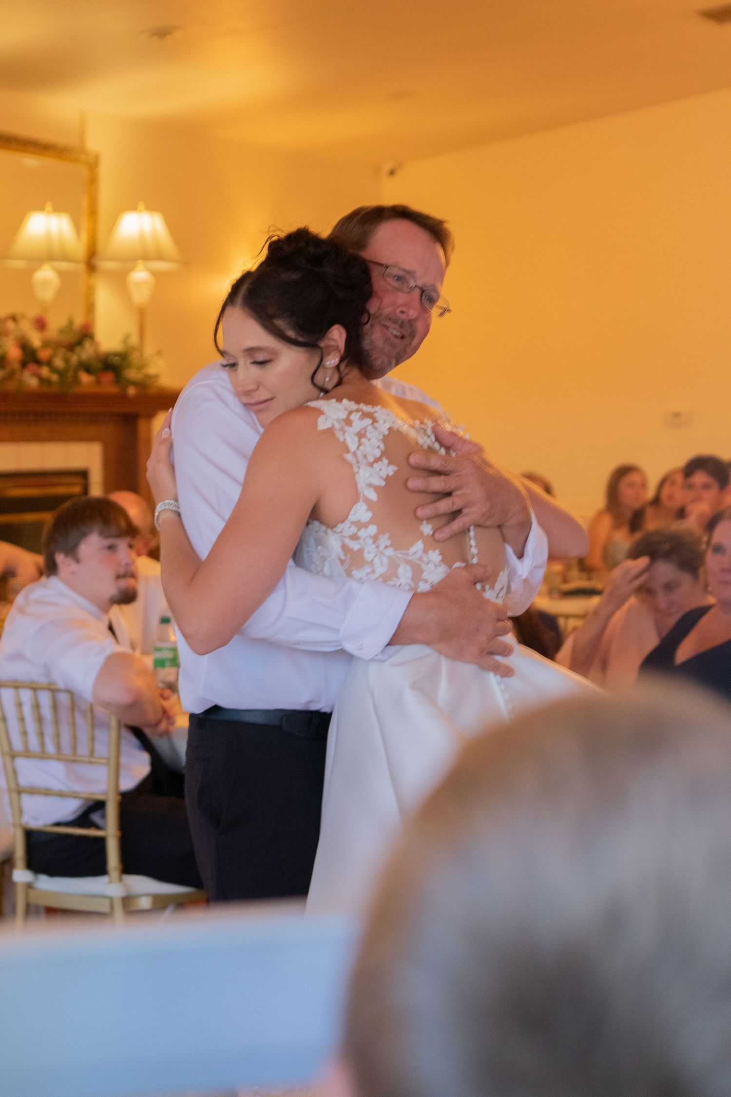 Couples slow dancing during an intimate wedding reception.