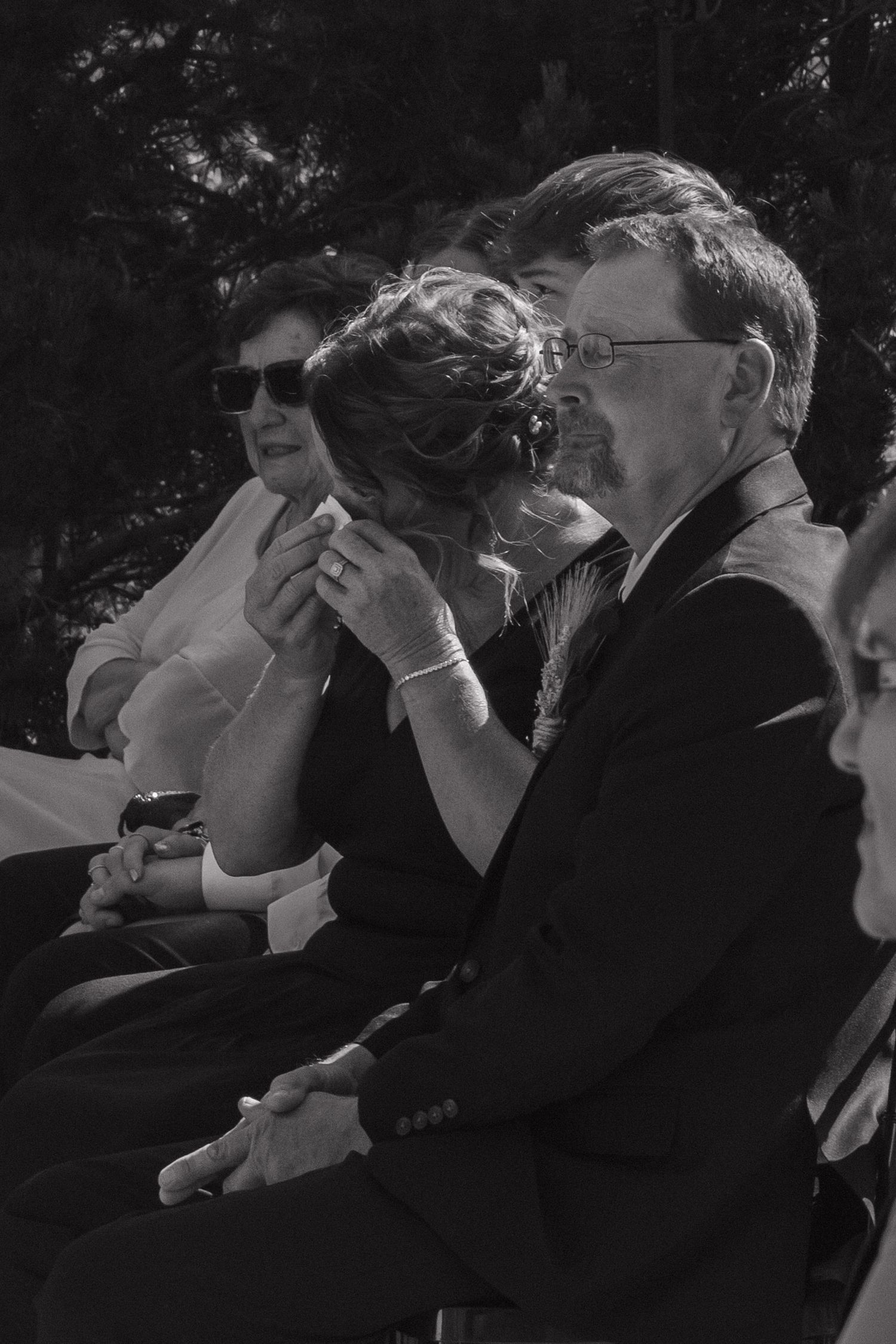 A series of black and white photos showing people covering their faces with their hands in similar poses.