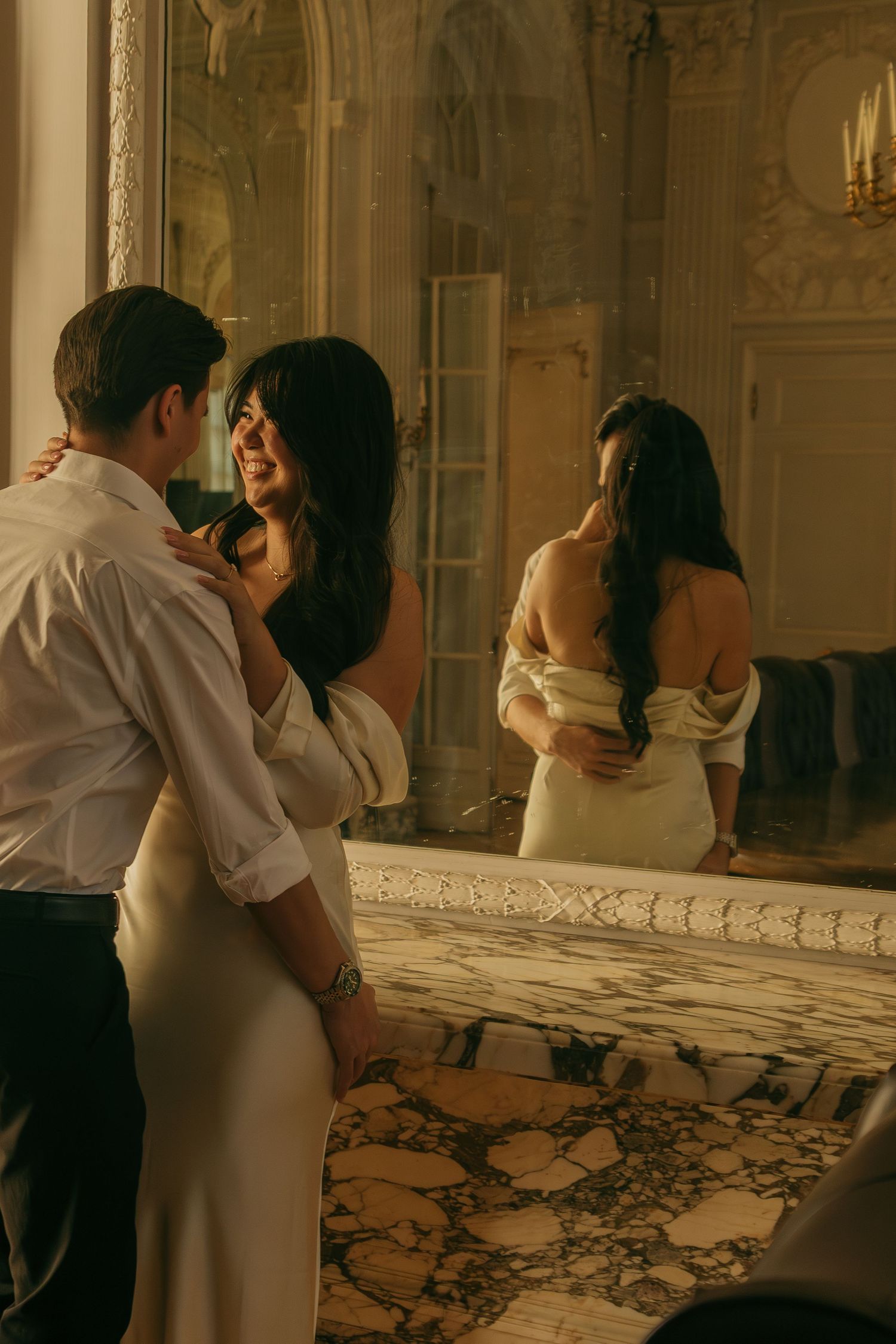 Two figures dance intimately in a luxurious room with ornate moldings and warm lighting.