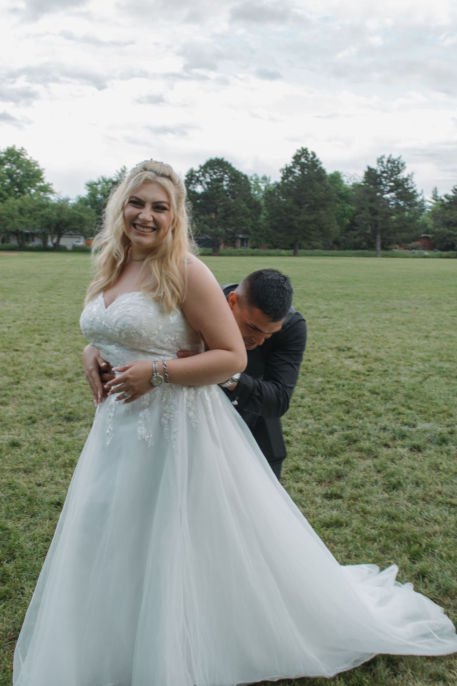 Joyful romantic moments captured in sequence between newlyweds in an outdoor field setting.