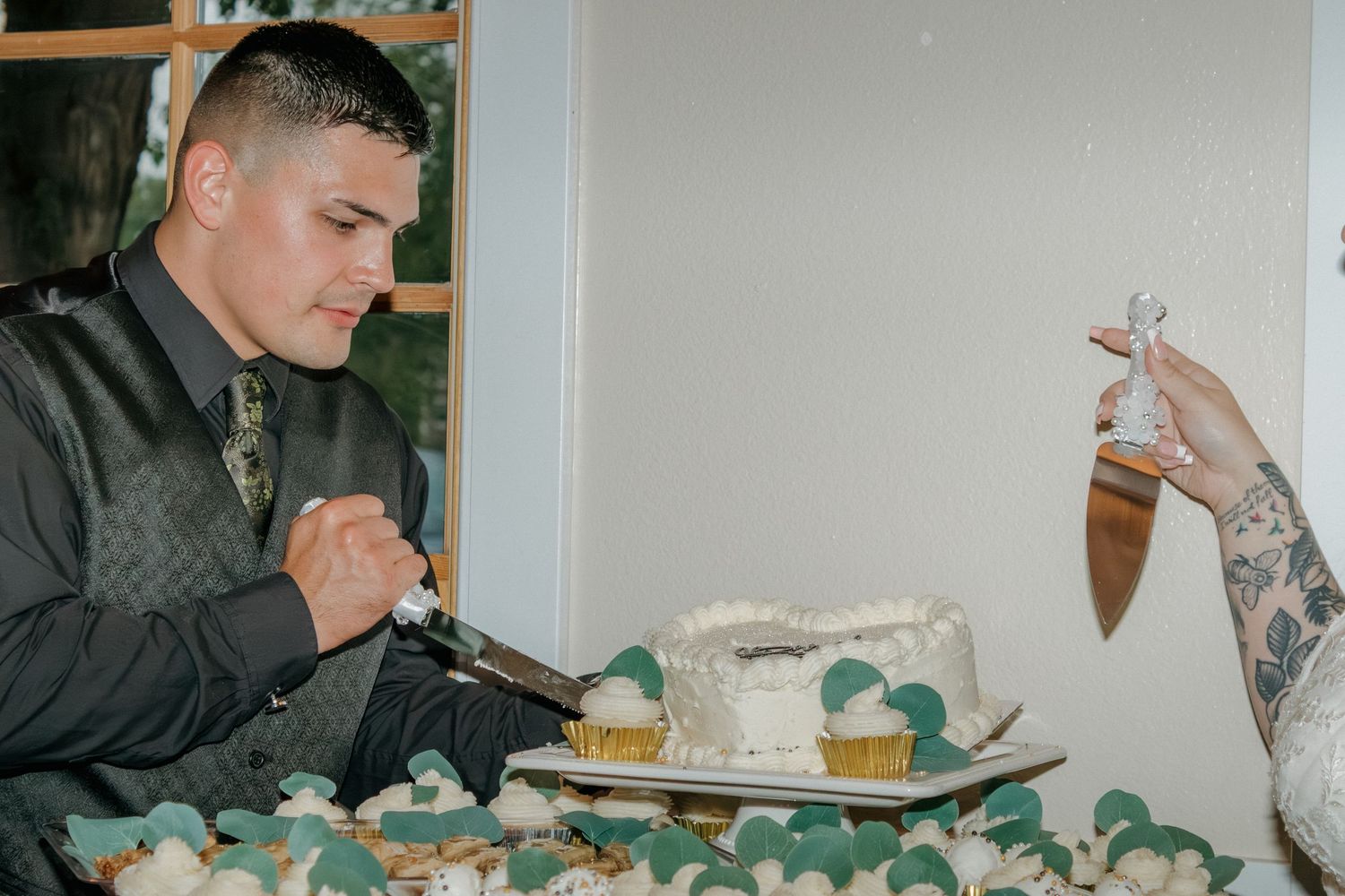 Traditional cake feeding ceremony between couple at wedding reception.