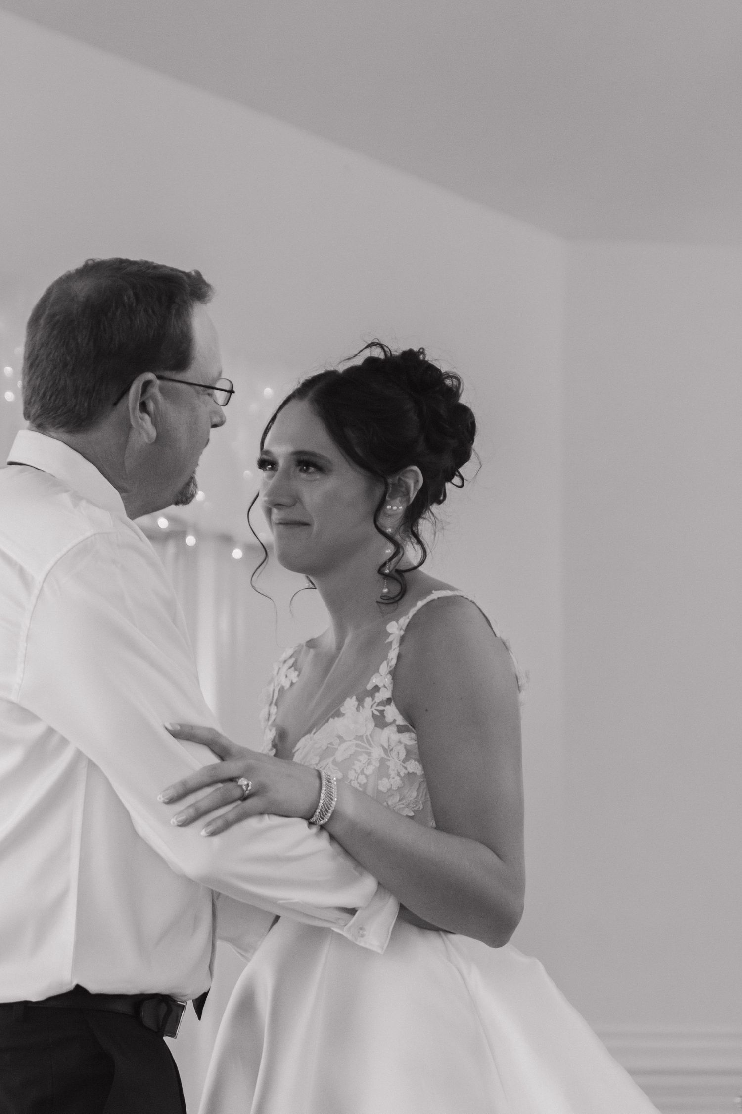 Emotional dance sequence captured in black and white during wedding celebration.