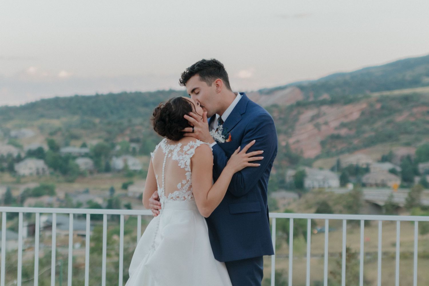 Romantic sunset moment captured on outdoor terrace with mountain backdrop.