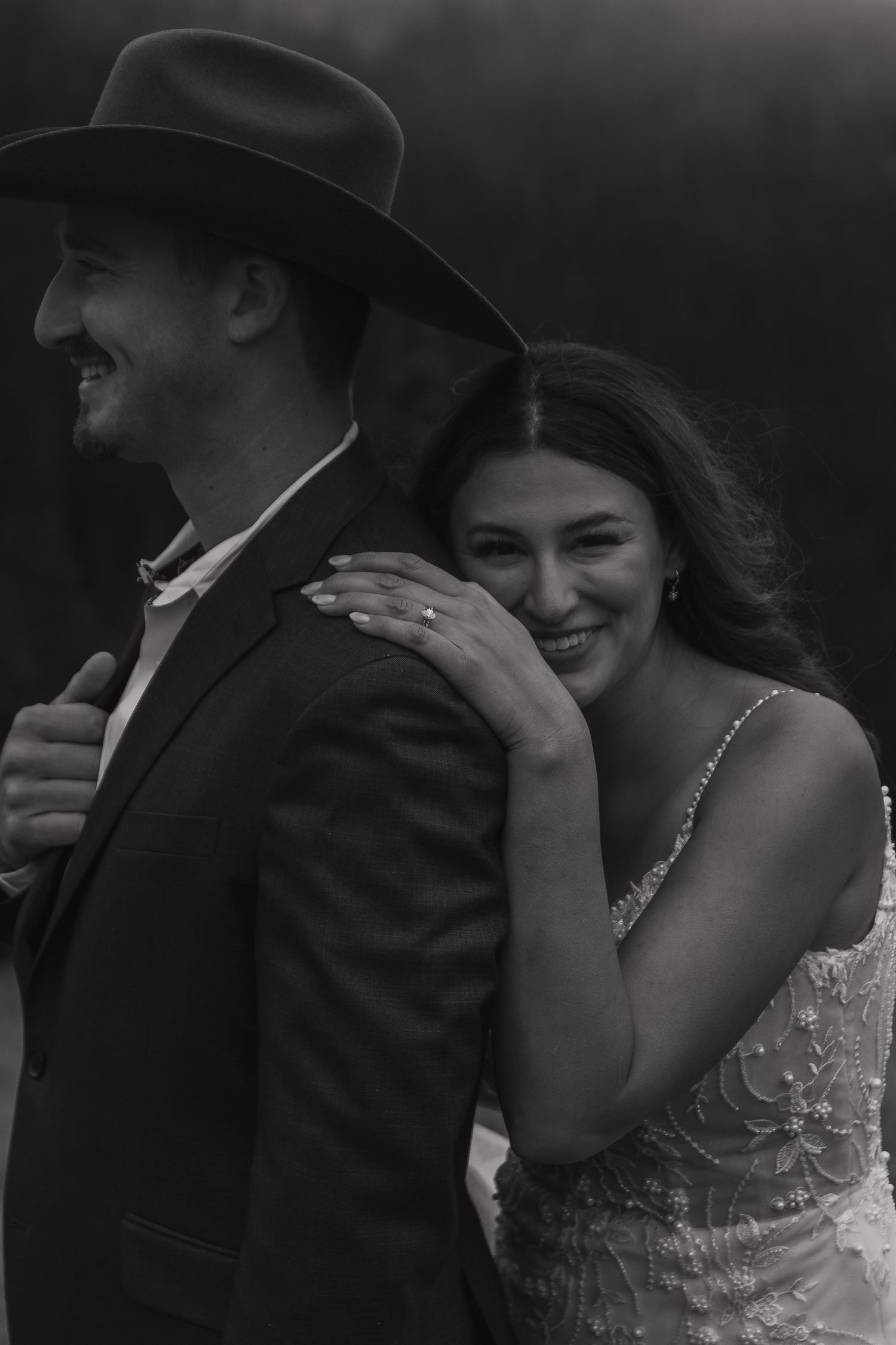 A tender black and white portrait of a couple sharing an emotional moment outdoors.