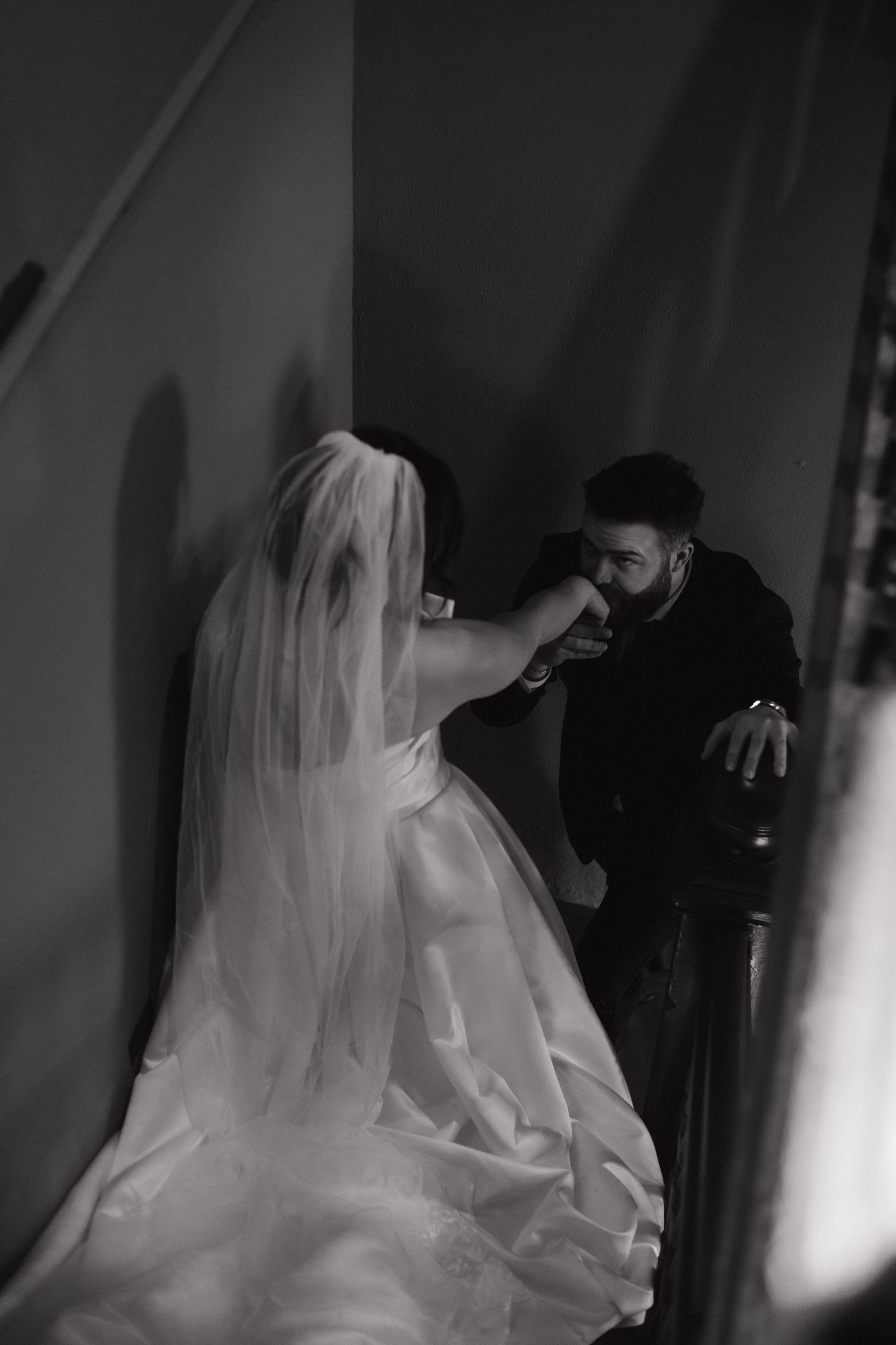 Dramatic black and white wedding photography sequence featuring flowing white dress and veil.