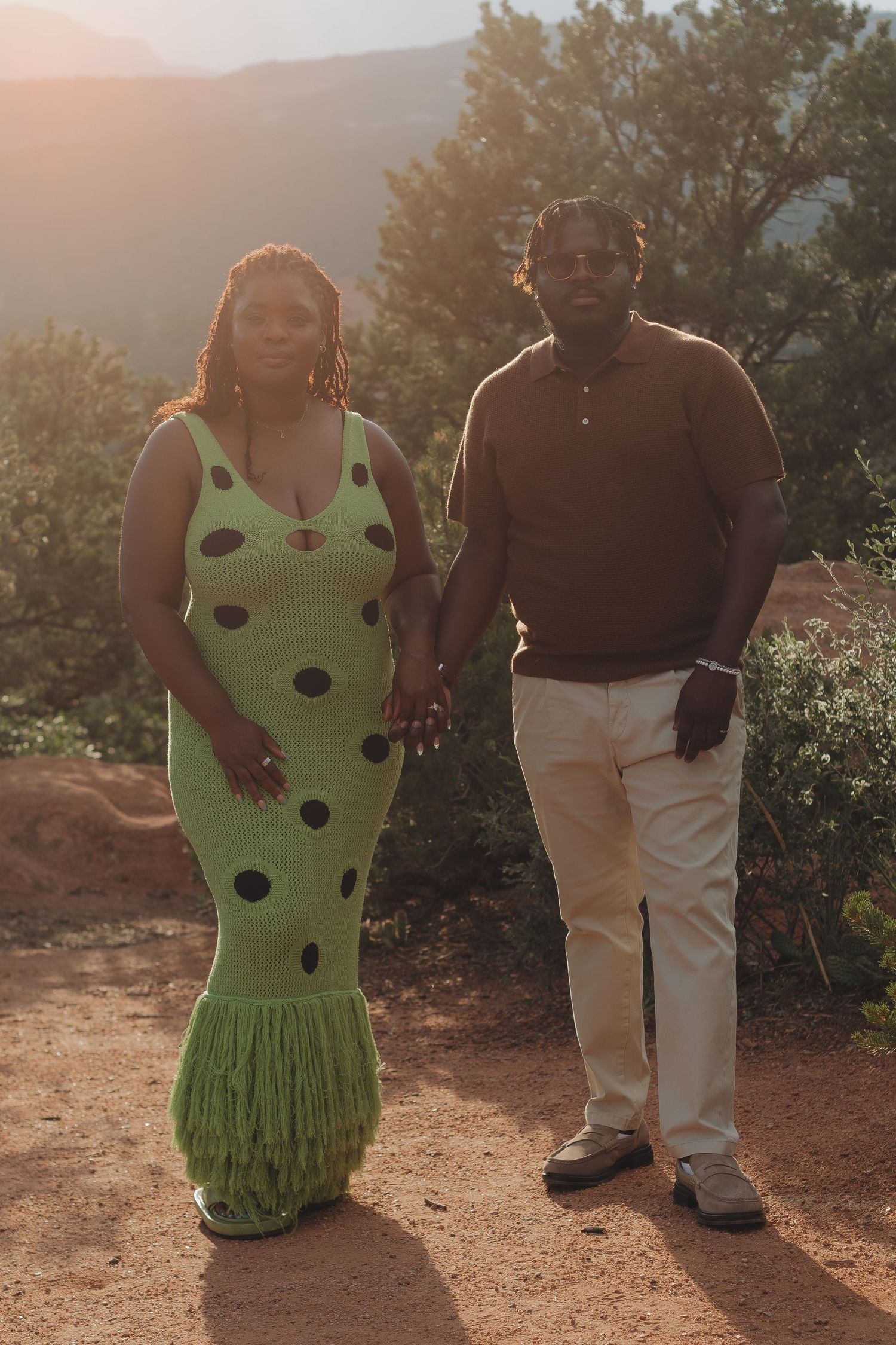 A romantic sunset photoshoot featuring a polka dot green dress against the red rocks of Garden of the Gods.