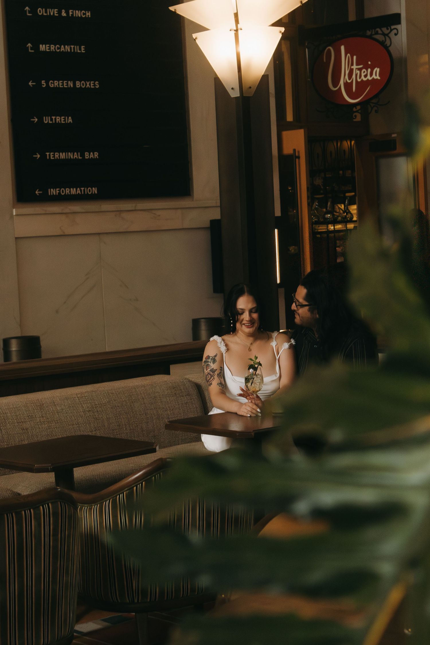 A moody indoor scene with decorative signs and dim lighting creating an atmospheric setting.