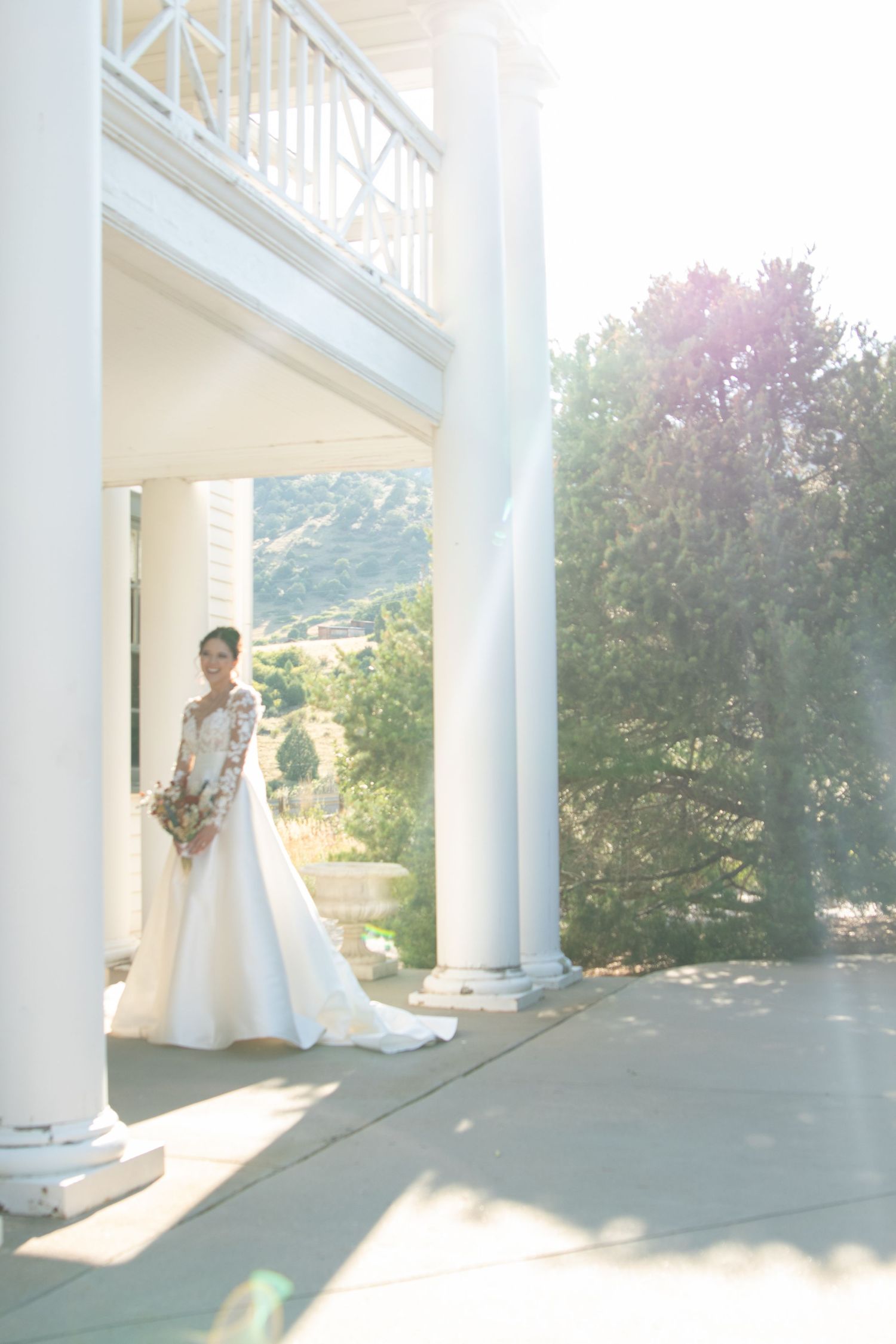 Ethereal wedding photography sequence with white columns and natural sunlight.