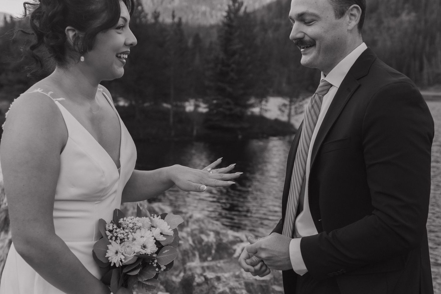 Black and white wedding portraits showing candid moments of joy and laughter between couple.