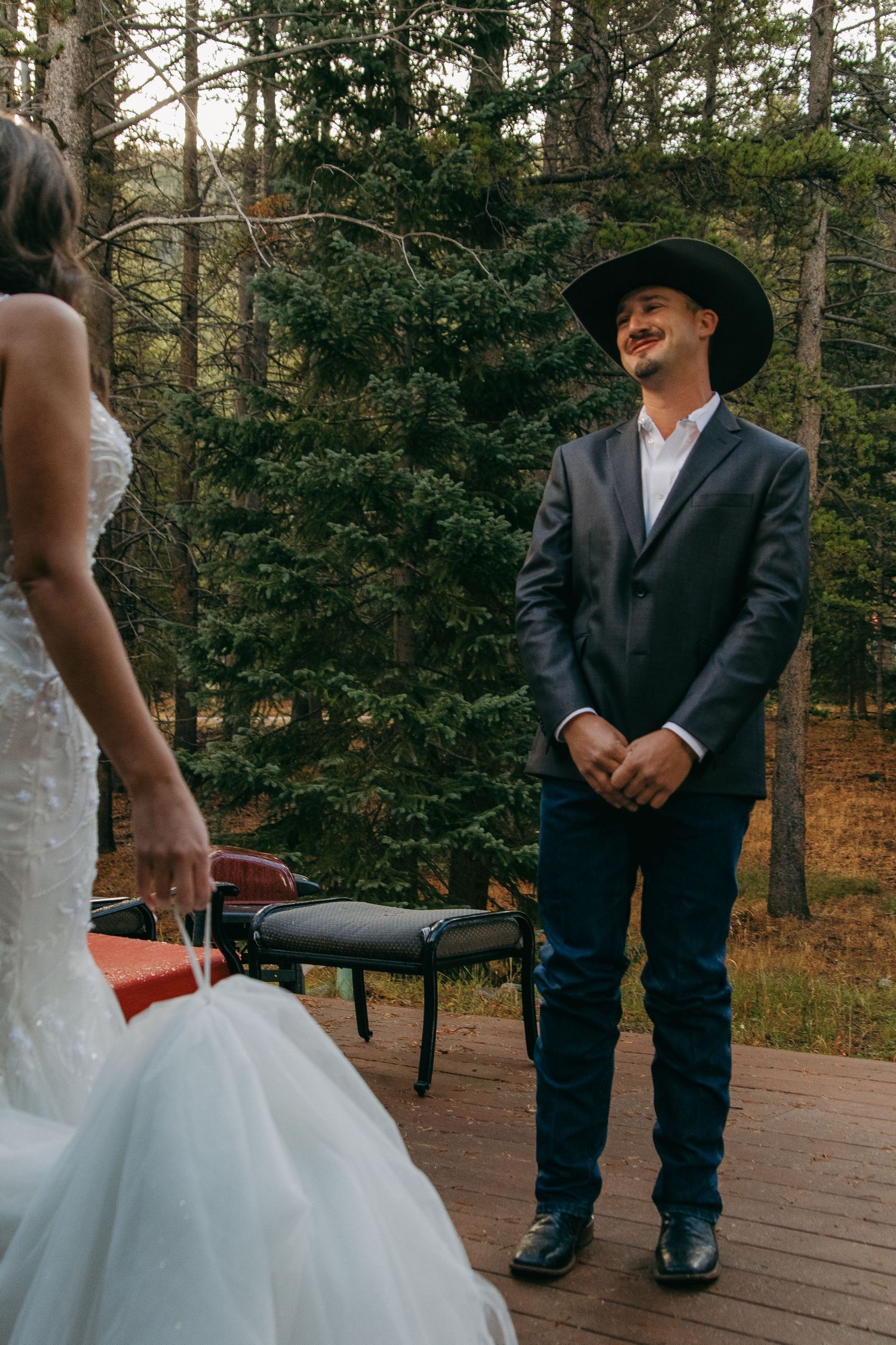 Wooden deck scene with cowboy boots and flowing white dress details.