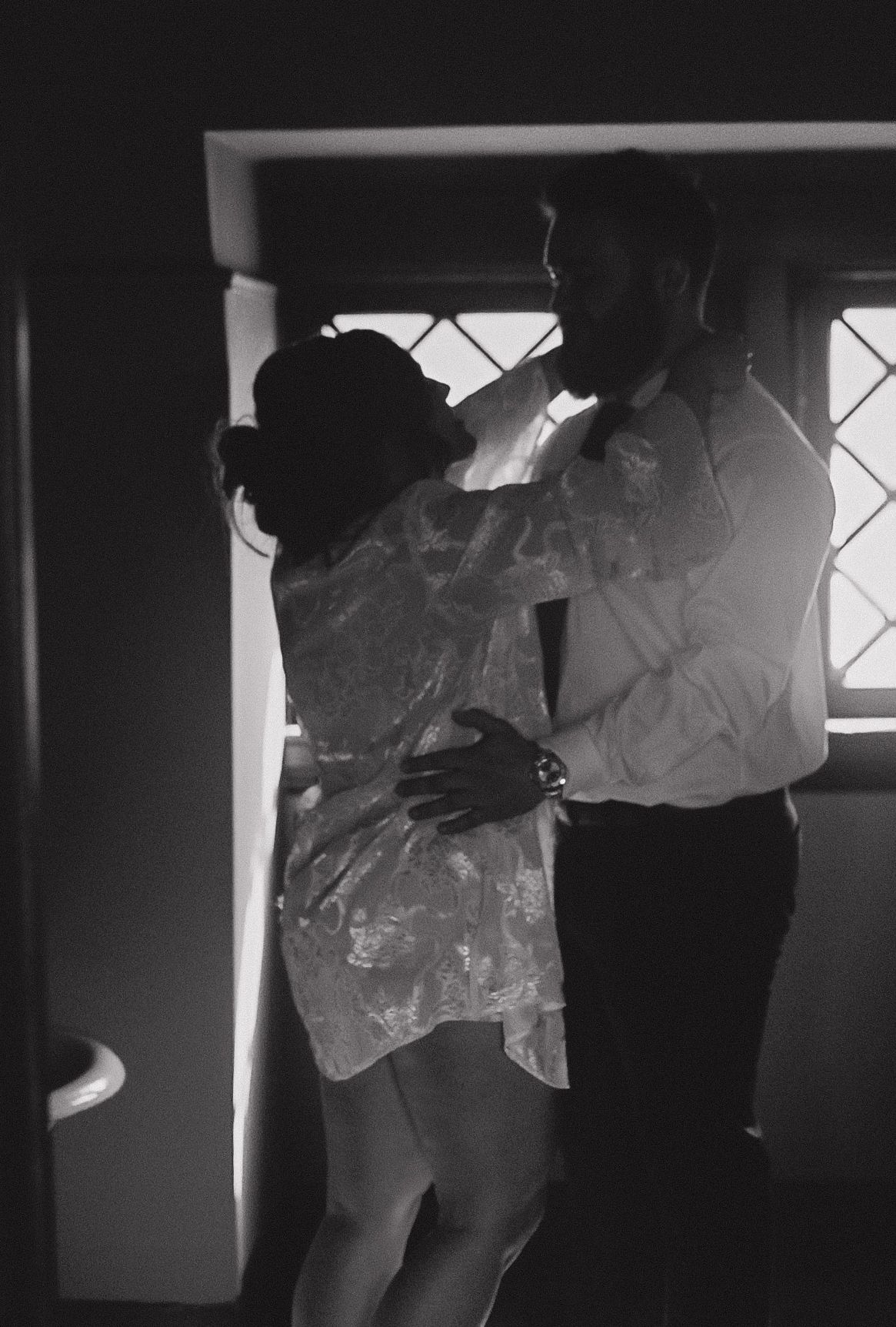 Silhouettes of people against window light creating dramatic shadows.