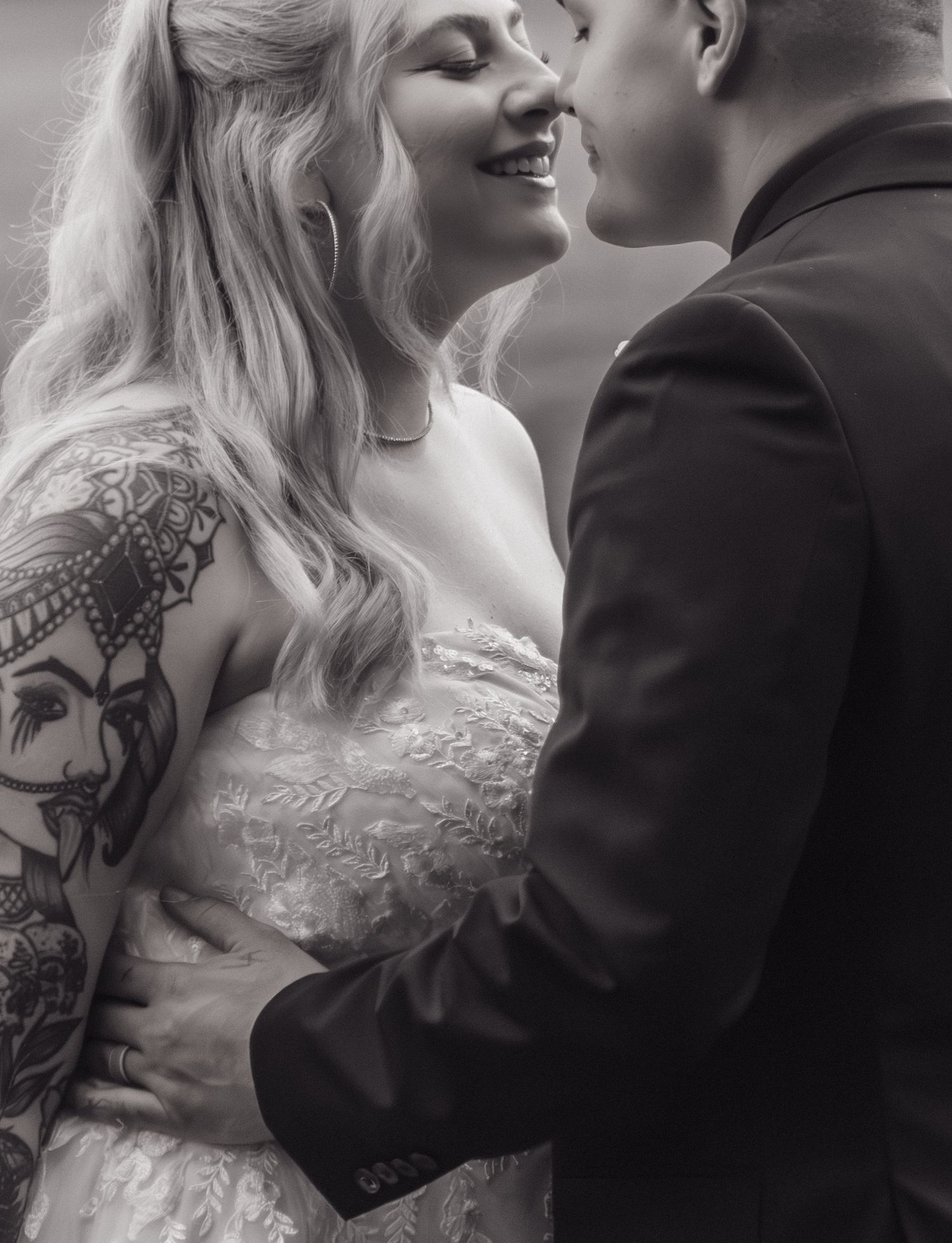 Black and white romantic wedding portrait showing close embrace.
