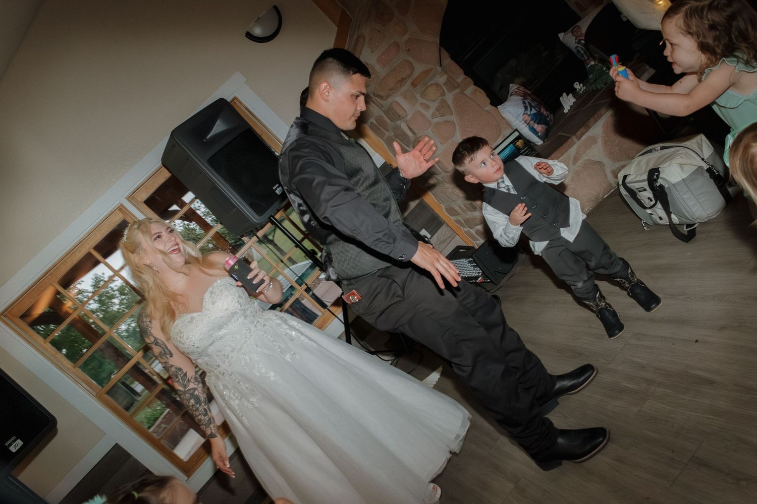 Wedding celebration on dance floor with guests enjoying lively entertainment.