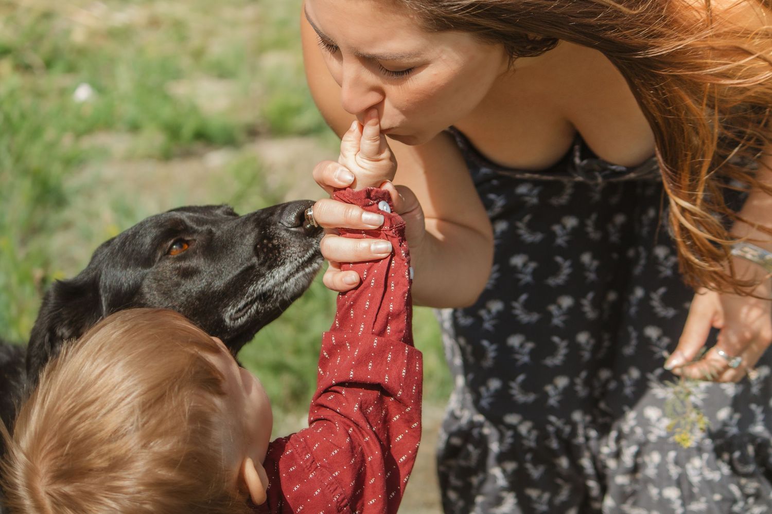 A sweet bonding moment captured in natural outdoor lighting.