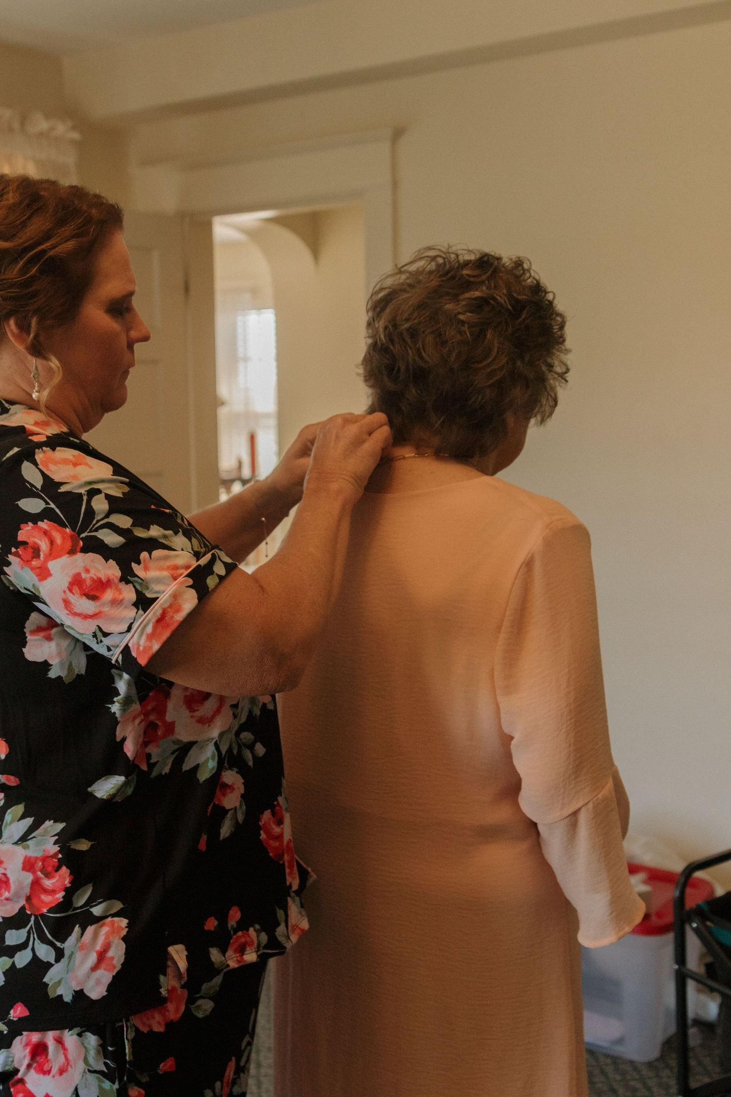 Getting ready scene with floral dress details while preparing for a special event.