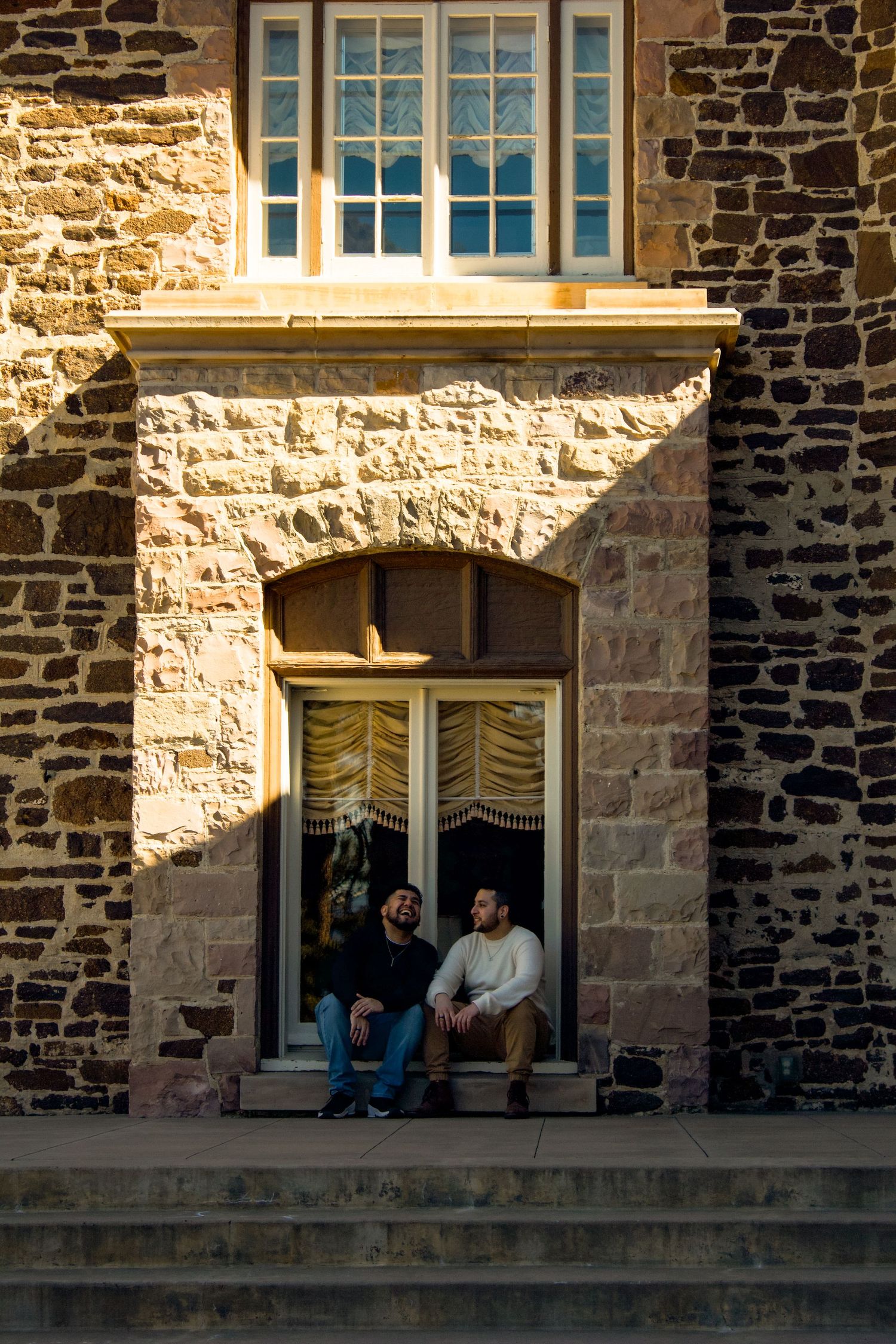 Looking out from stone windows of a historic building at golden hour.
