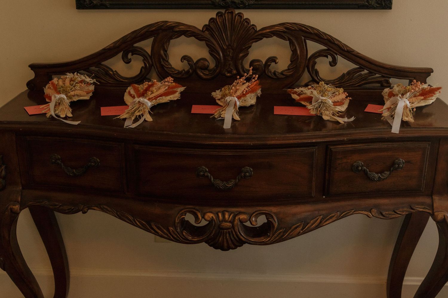 Decorative dark wood carved furniture piece with baroque-style ornamental details and scrollwork design.