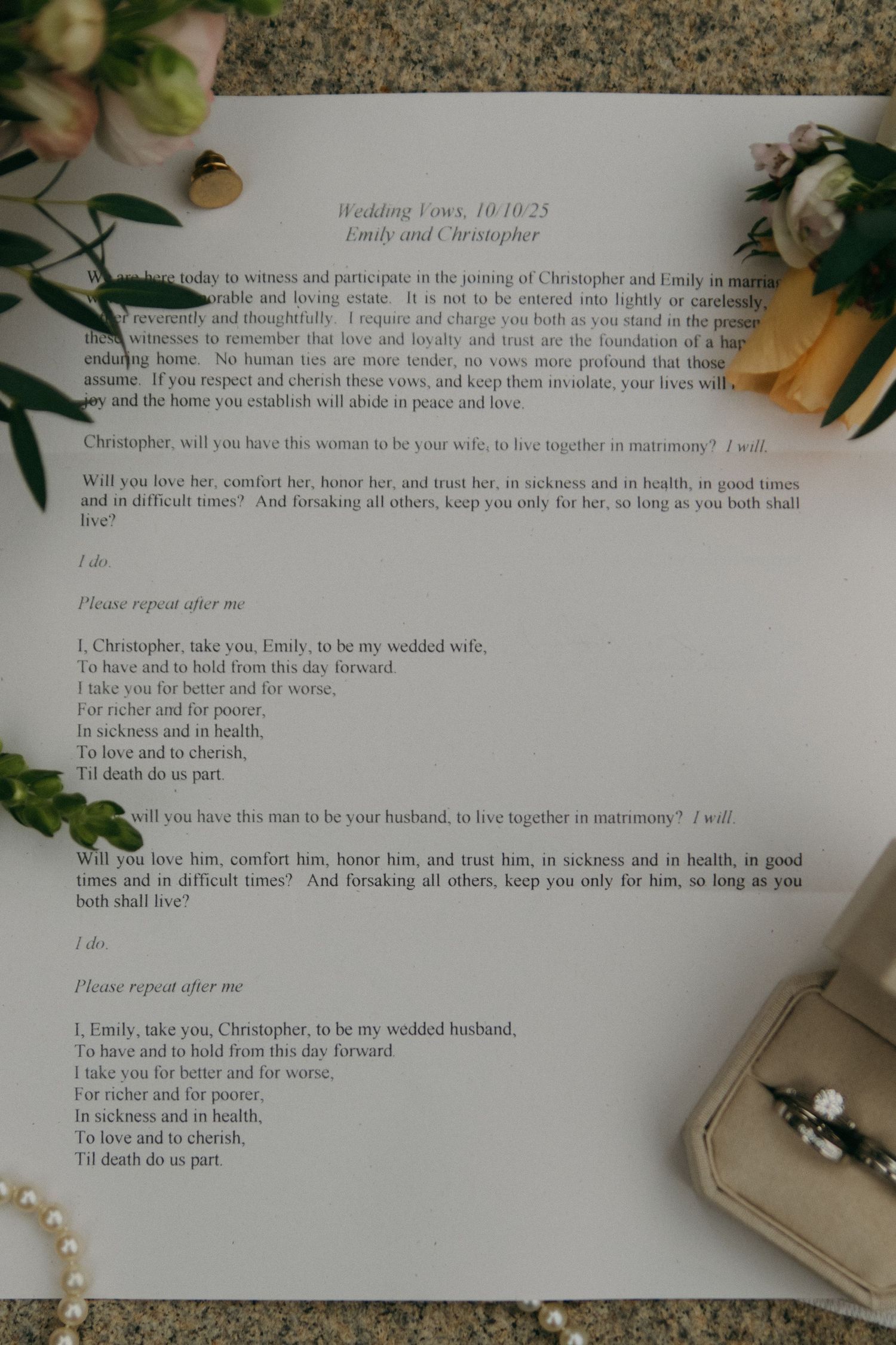 Wedding ceremony vows and text printed on white paper with decorative greenery and floral elements.