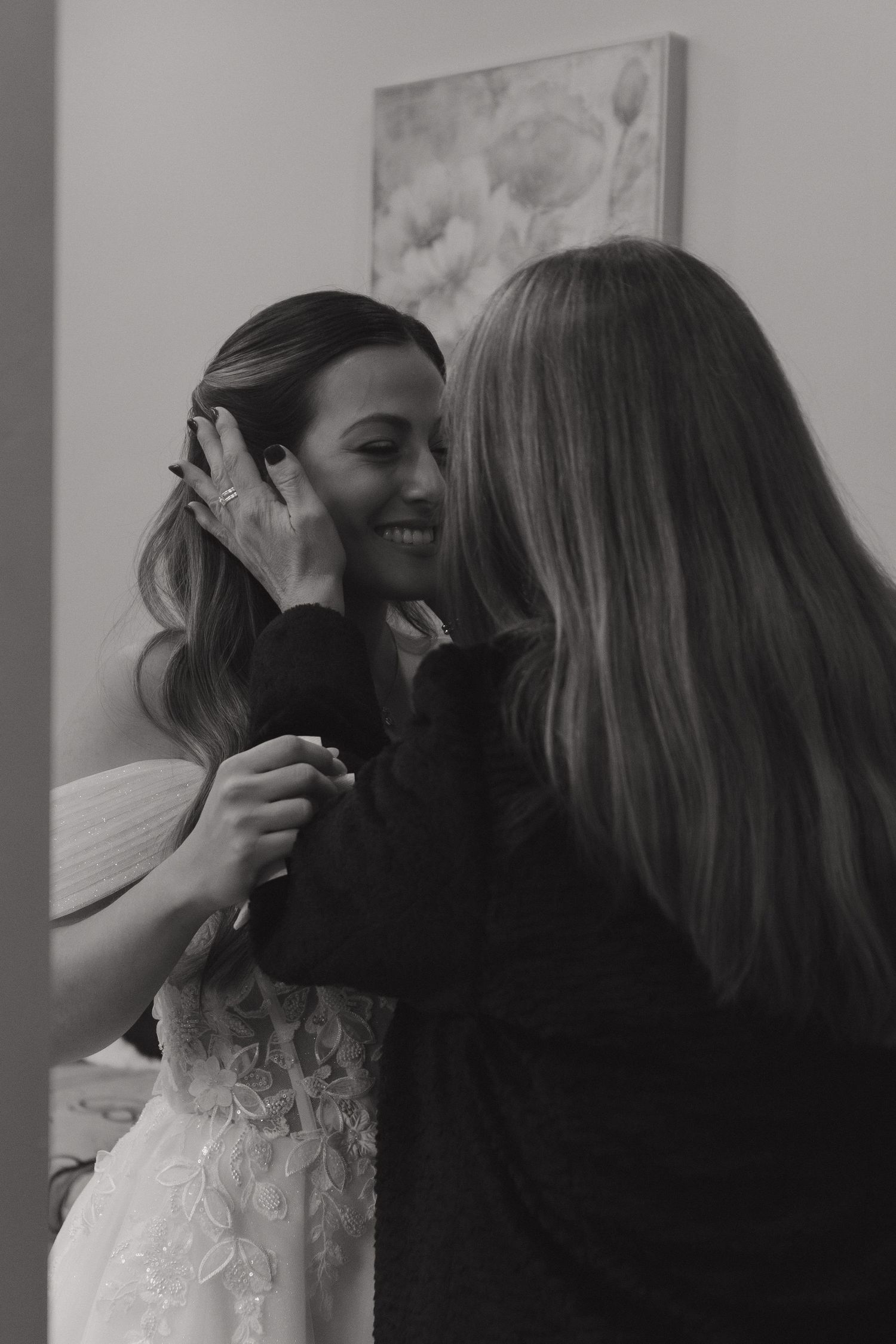 Joyful candid moments shared during wedding preparations in a bright room.