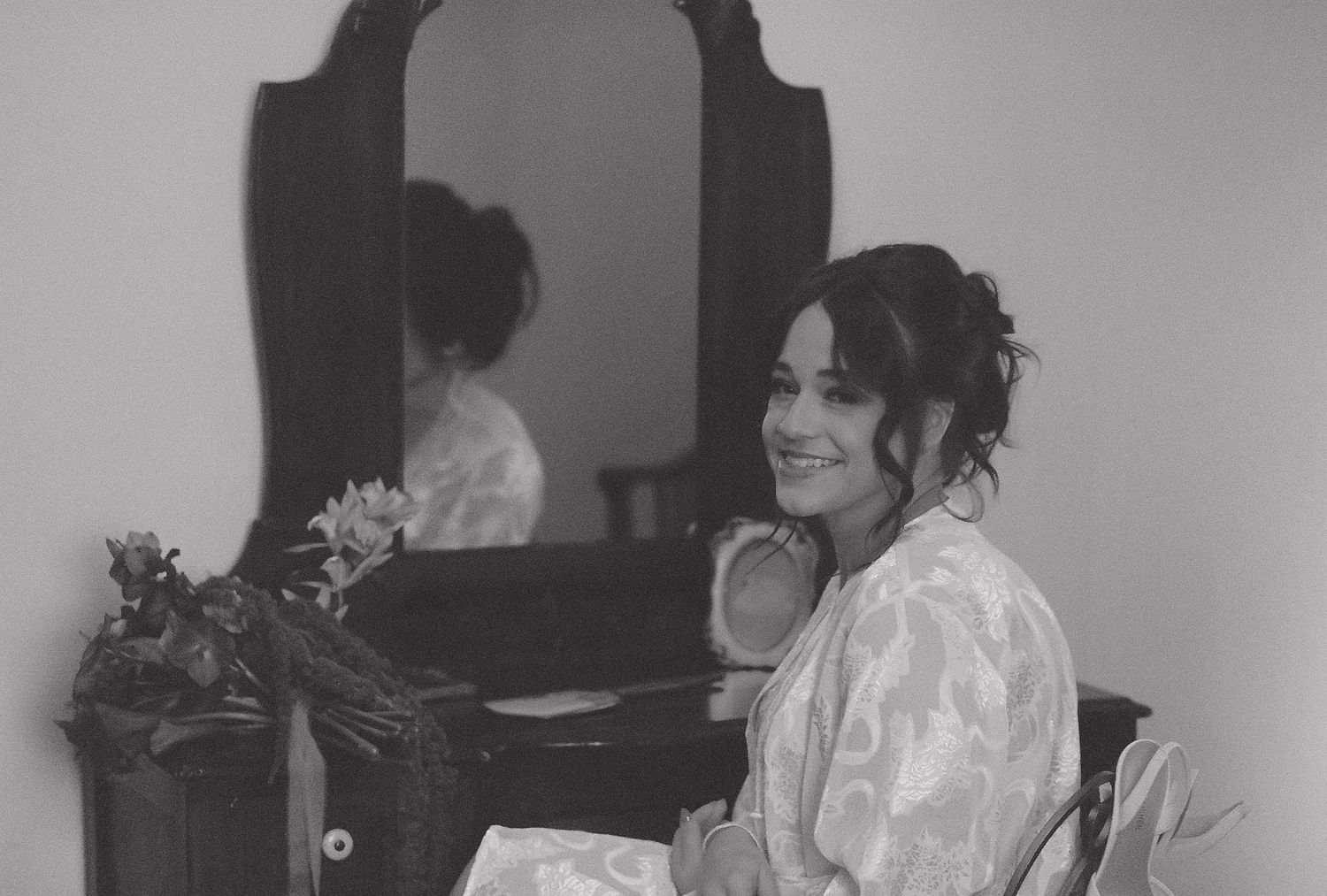 Wedding day preparation moments captured in black and white.