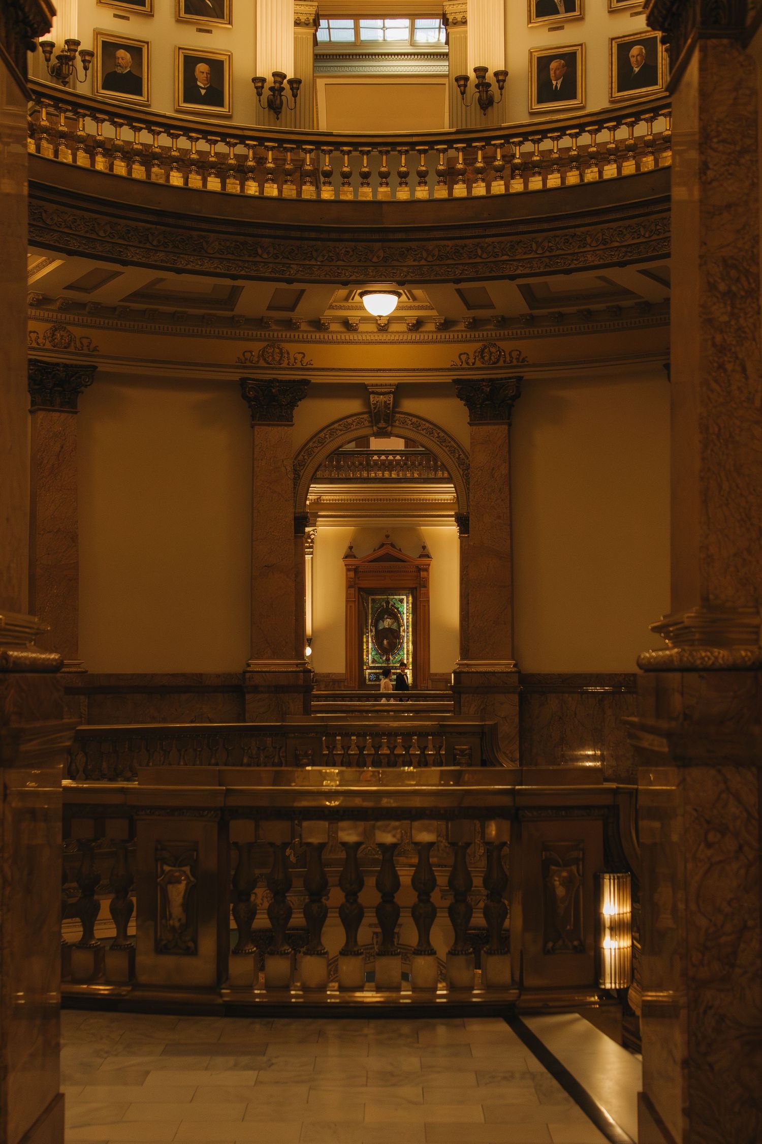 Grand rotunda interior with ornate balustrades and classical architectural details.