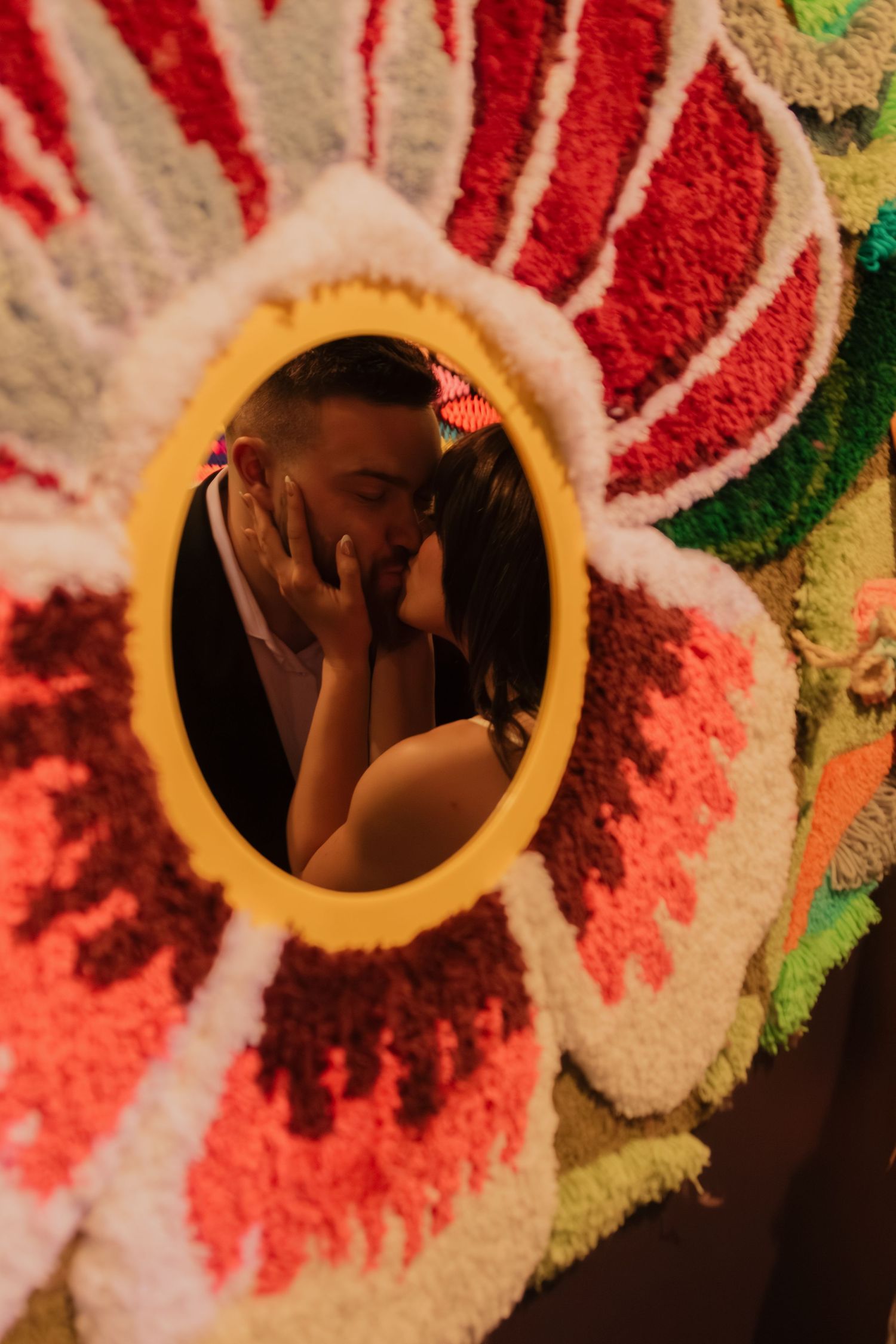 Close-up sequence of figures looking through a colorful kaleidoscope lens with red and green patterns.
