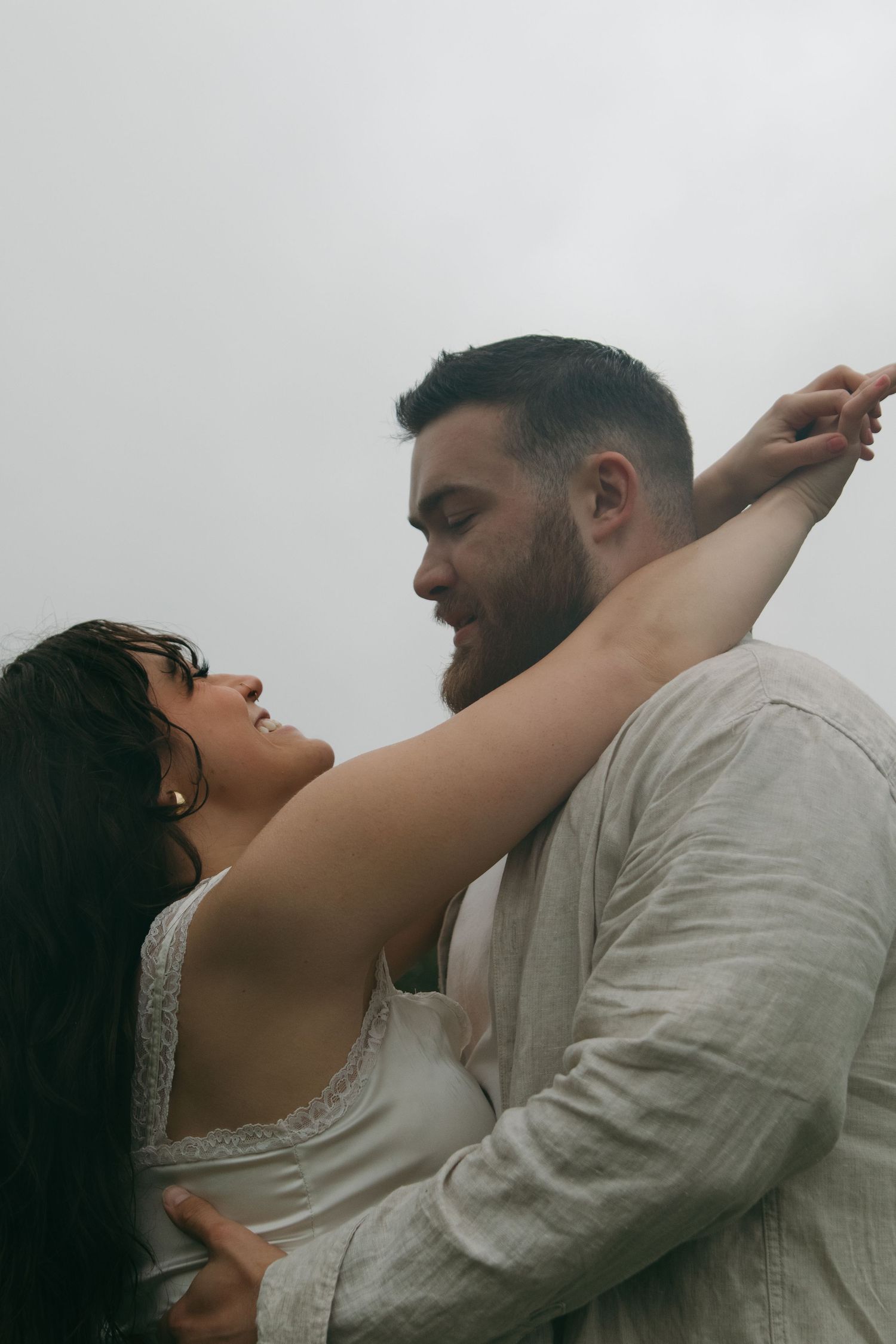 A romantic couple embraces intimately against a light background in a series of tender moments.