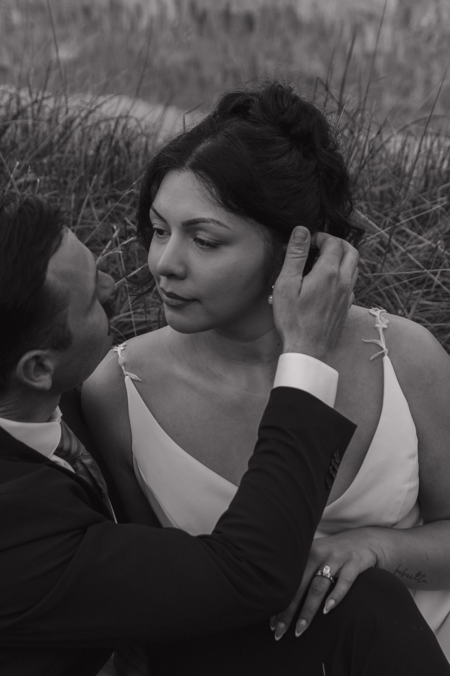 An intimate black and white wedding photo showing a tender embrace.