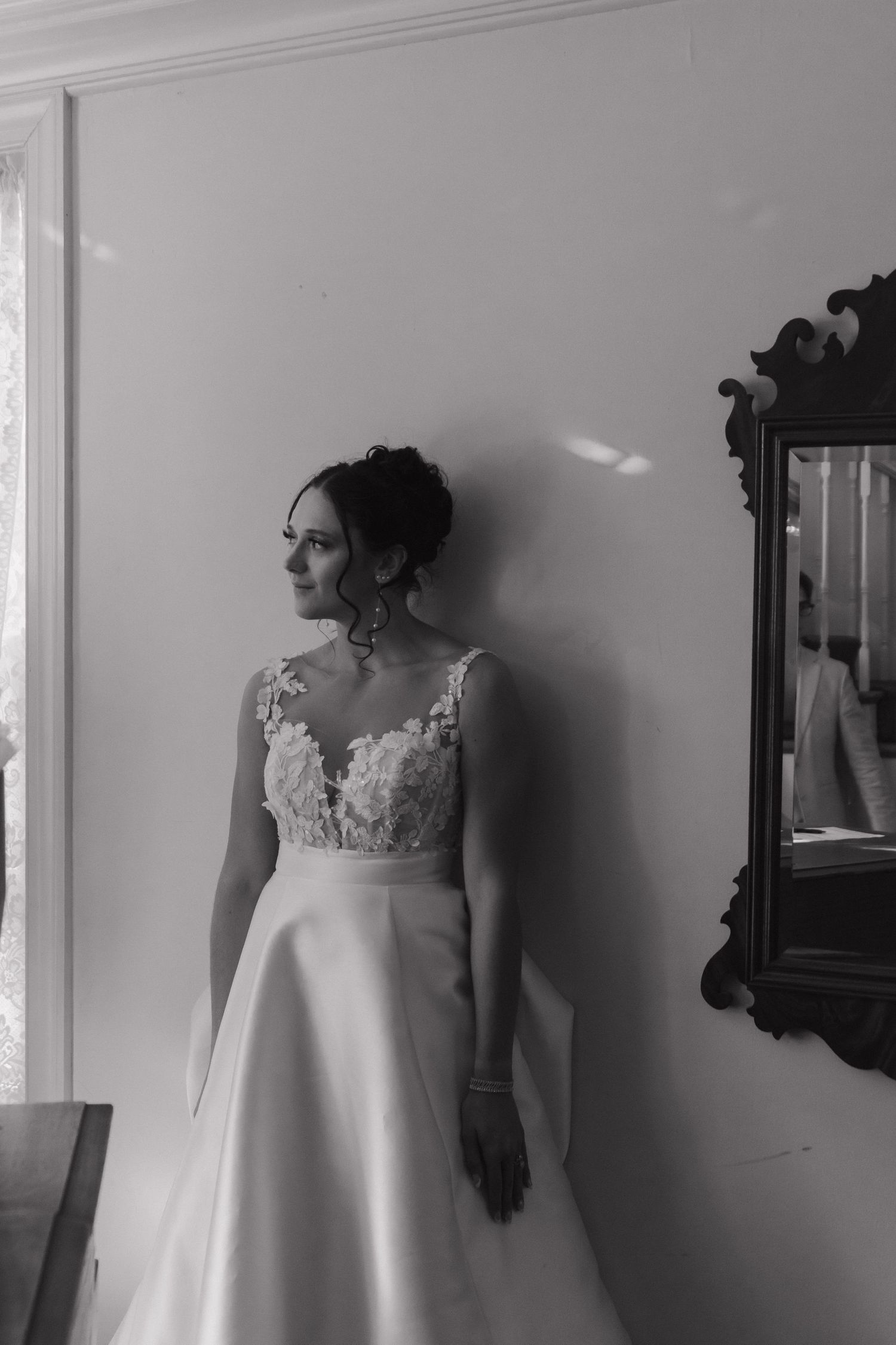 Black and white portrait featuring elegant bridal dress details.