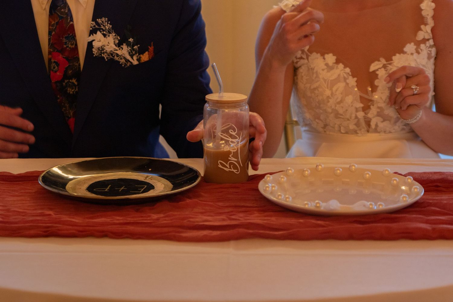 Wedding reception table setting with elegant details and soft lighting.