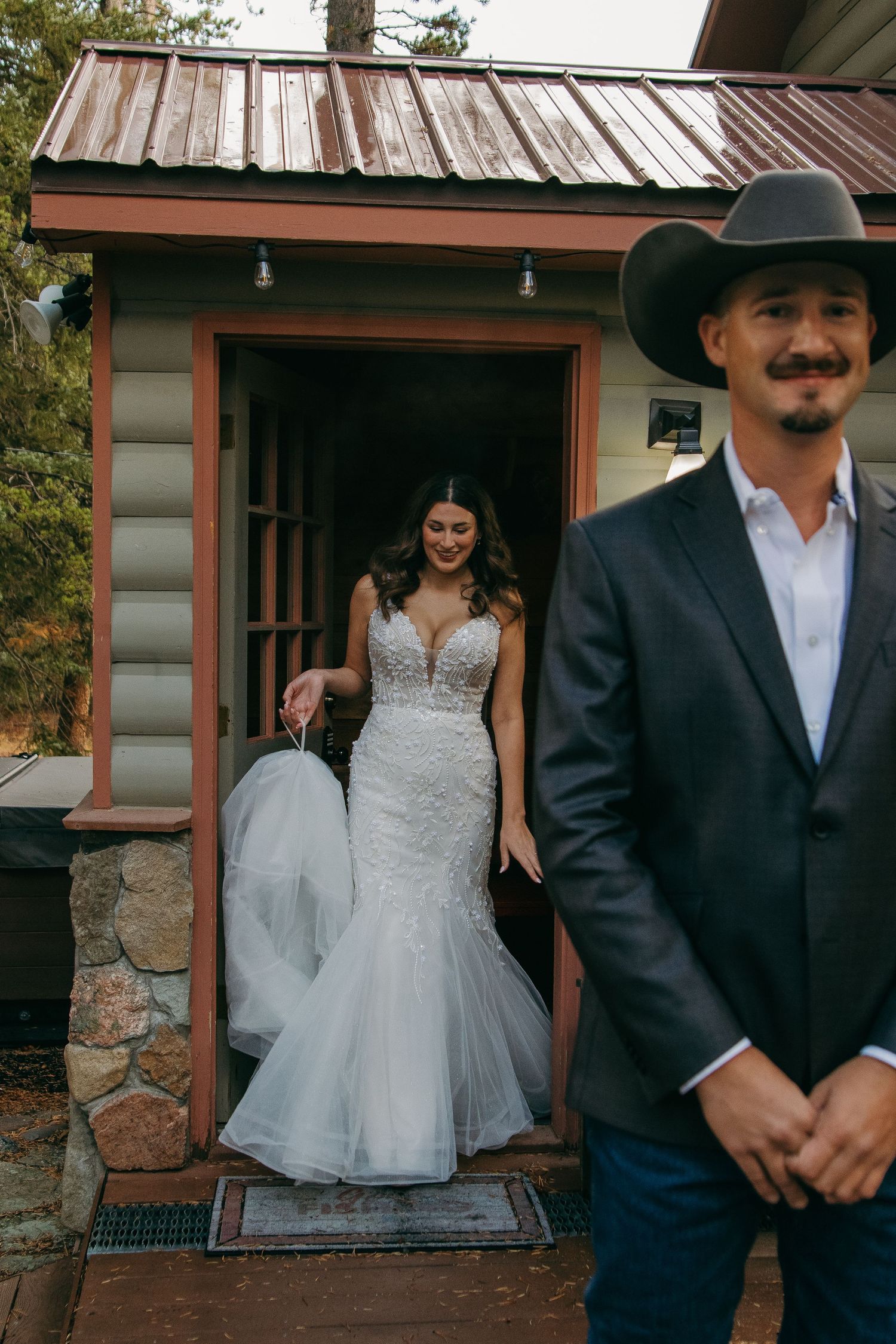 A rustic cabin porch scene with western style attire and flowing white dress.
