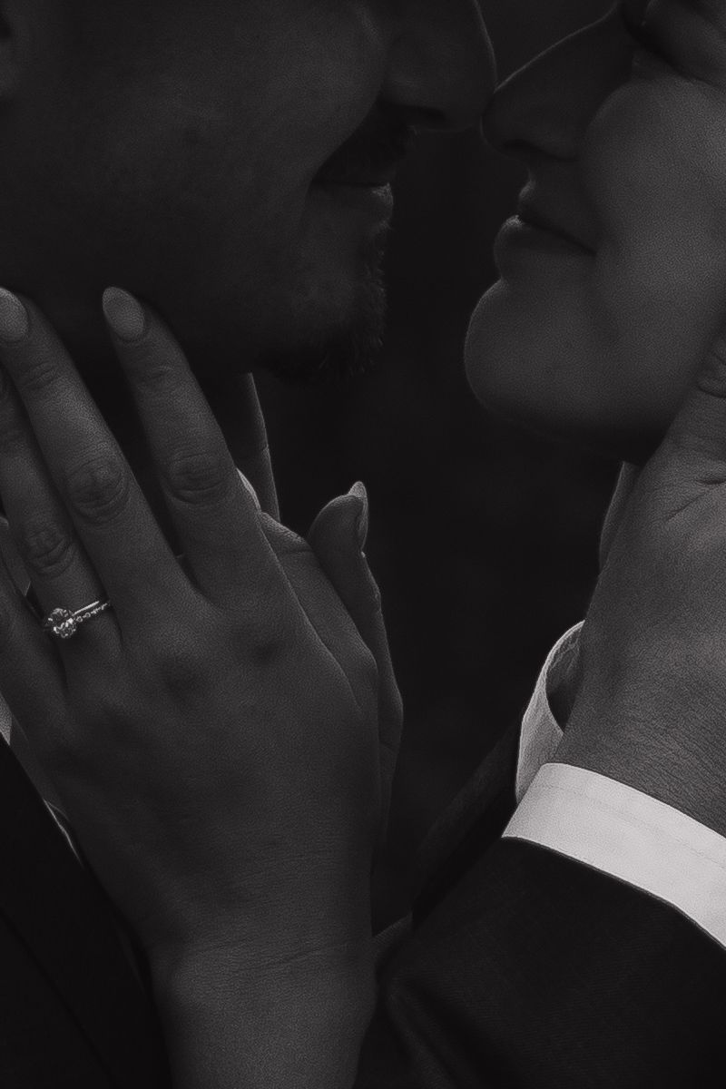 Close-up of hands with wedding rings showing tender moments during a ceremony.