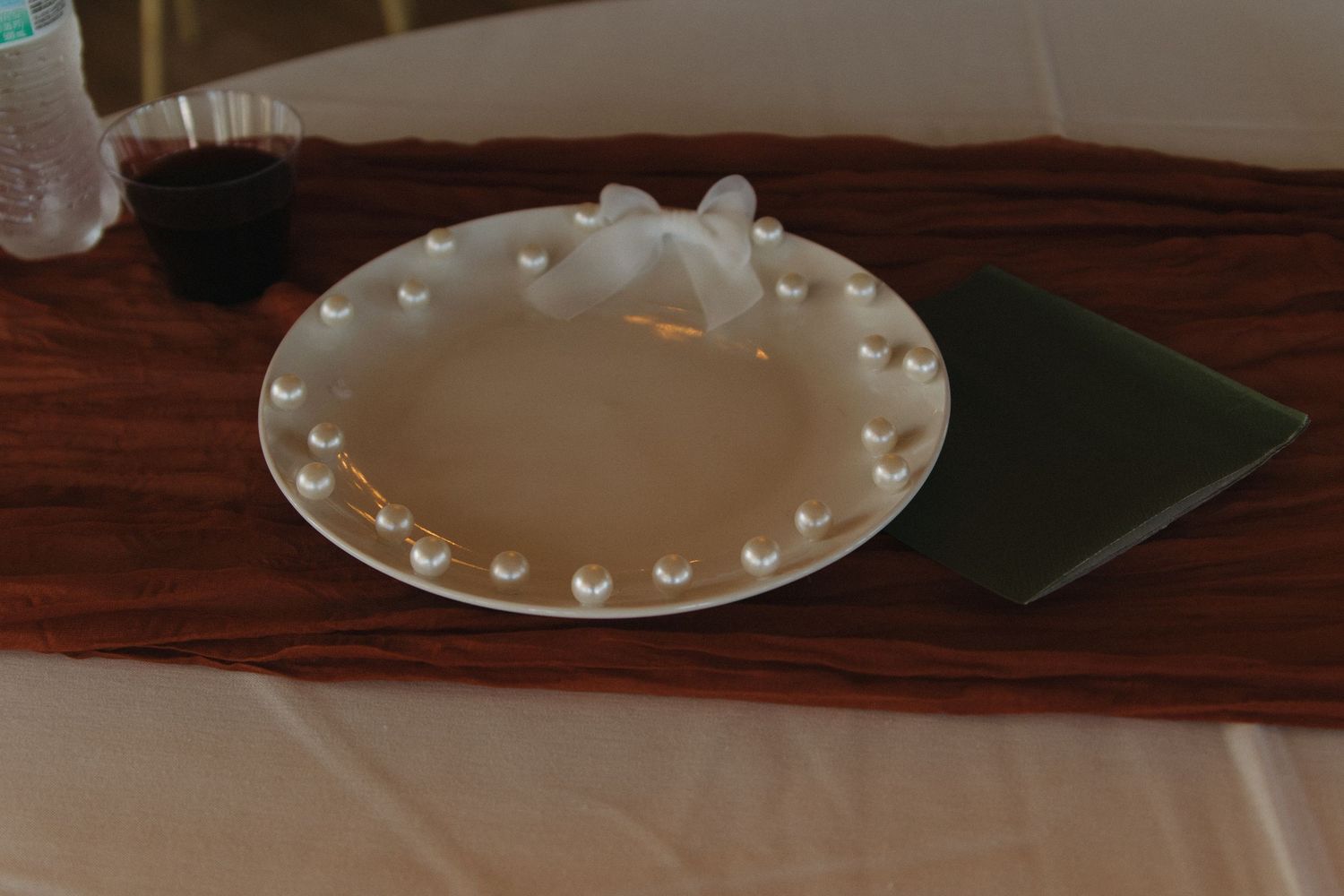 Decorative white plates with heart designs arranged on dark wooden surfaces.