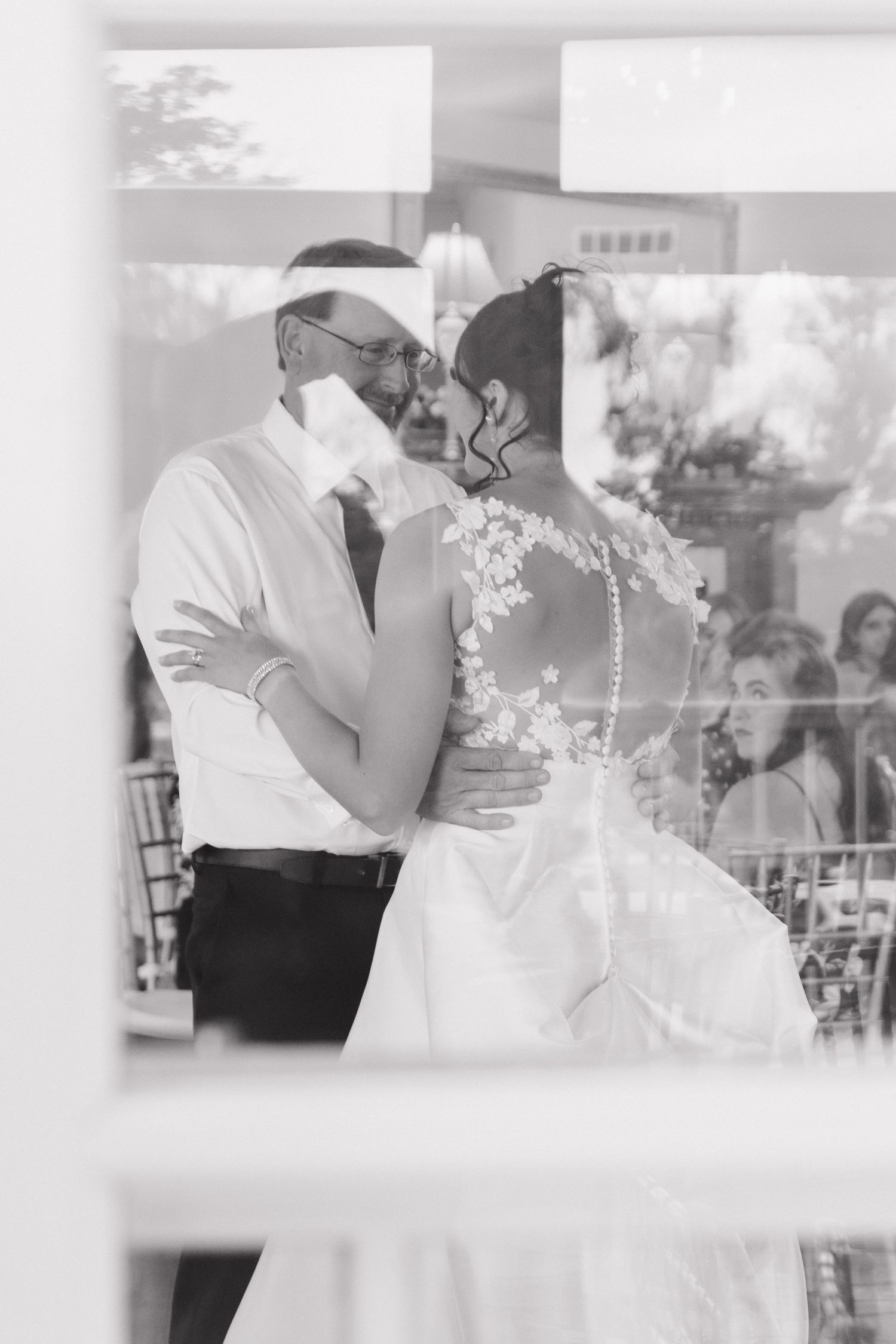 Black and white photo of an intimate dance moment during a wedding reception.