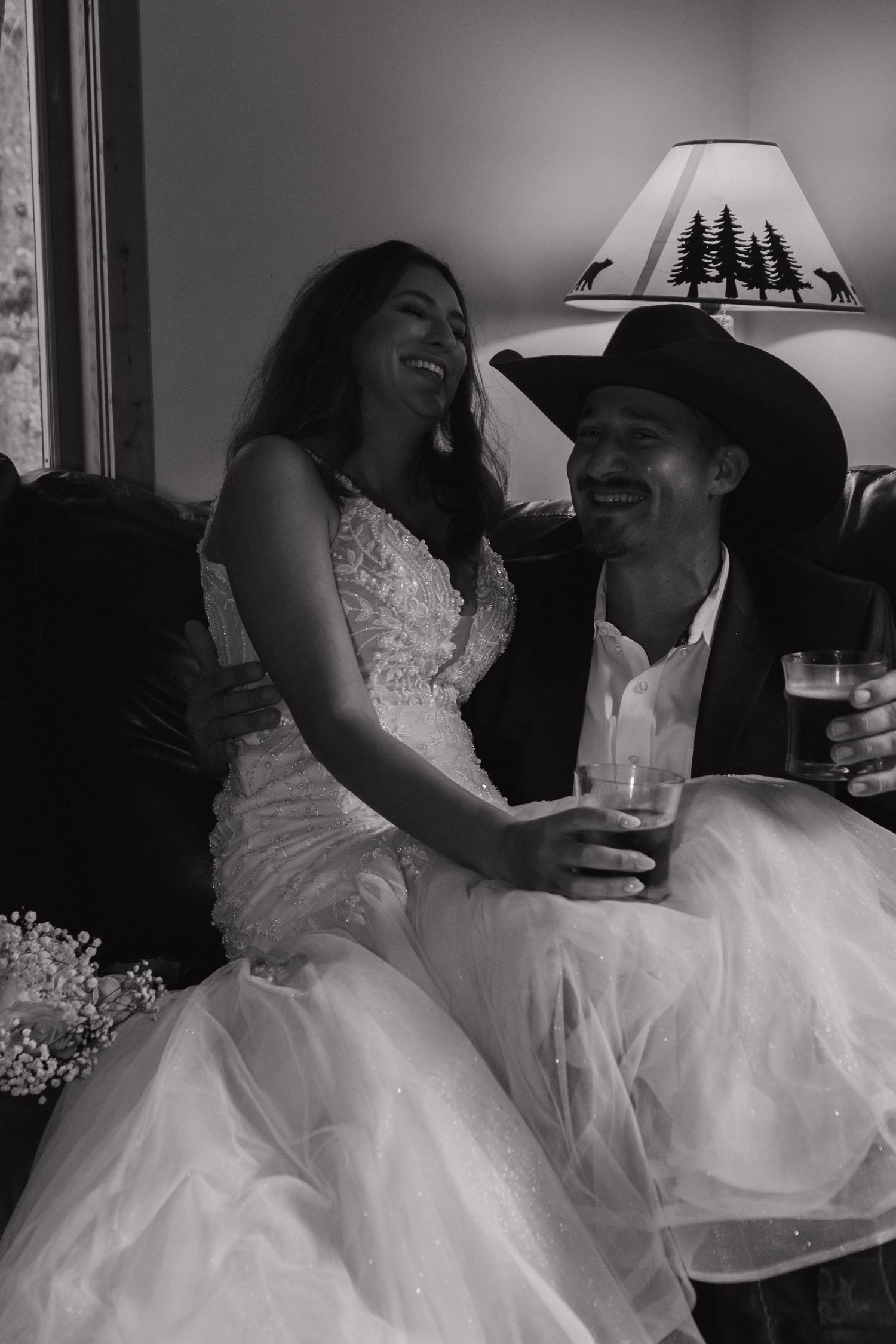 A joyful moment captured in black and white showing laughter and celebration in formal attire.