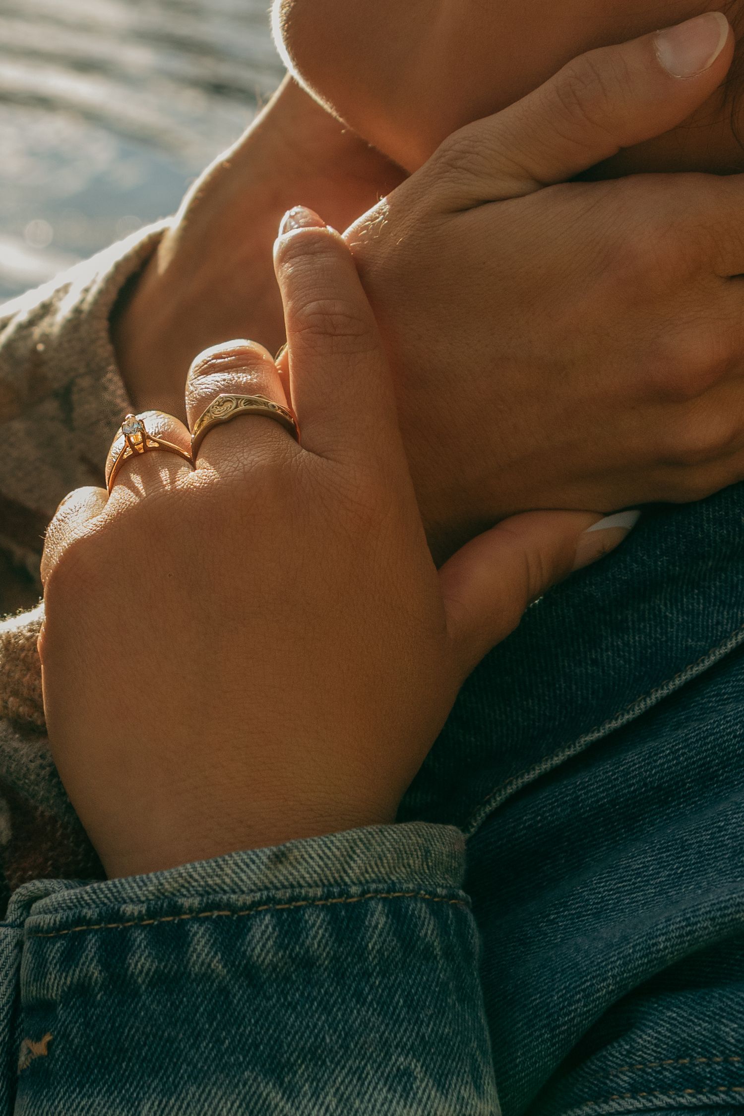 Close-up sequence of hands resting on denim fabric in warm sunlight, creating a serene and intimate composition.