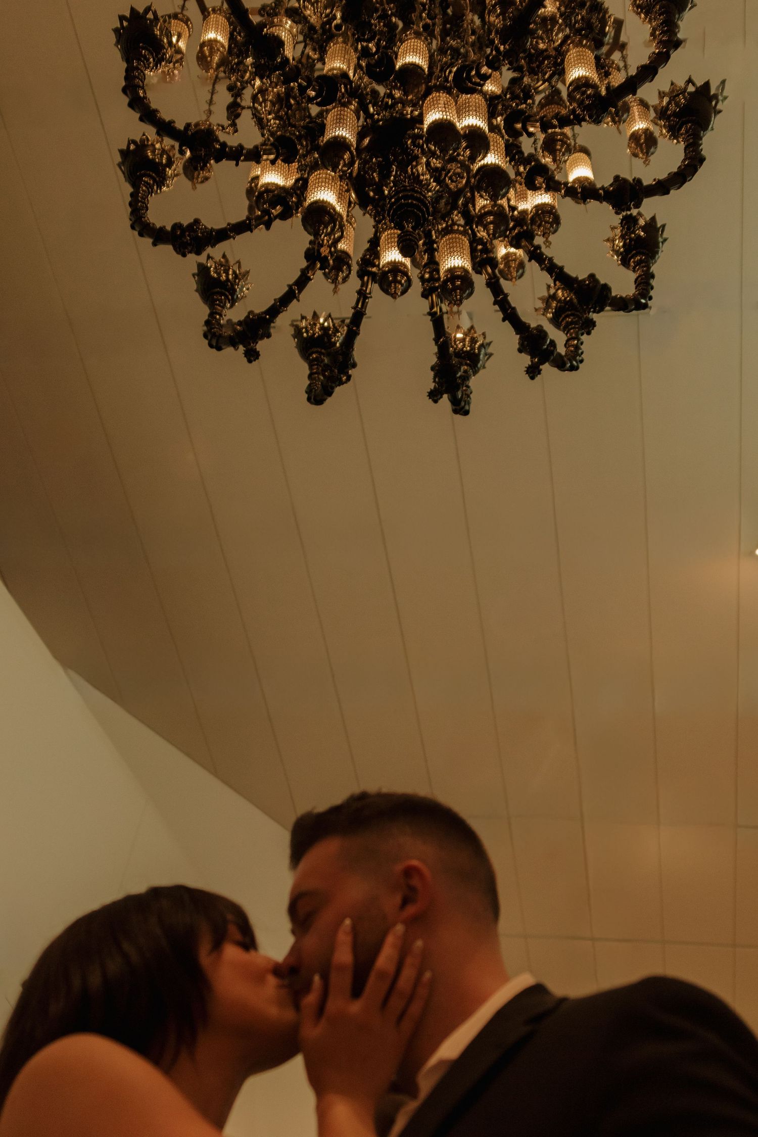 Elegant chandelier hangs above intimate gathering.