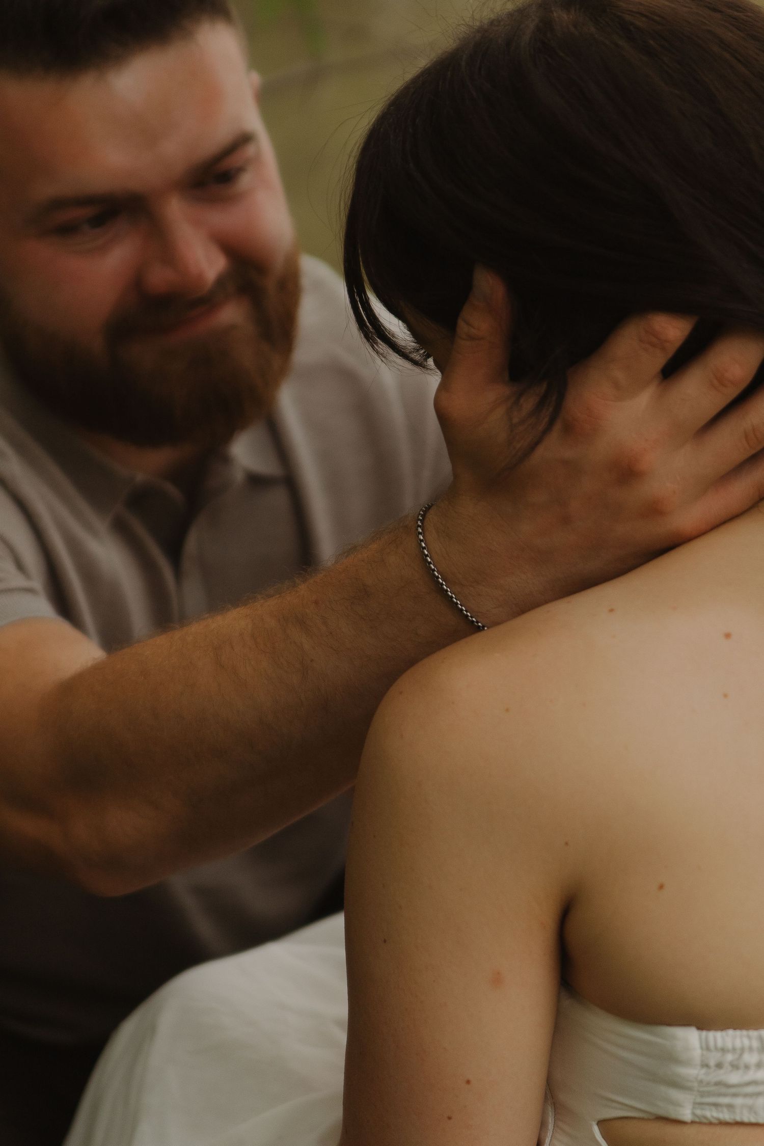 Tender moment shared between two people with gentle touches and warm lighting.