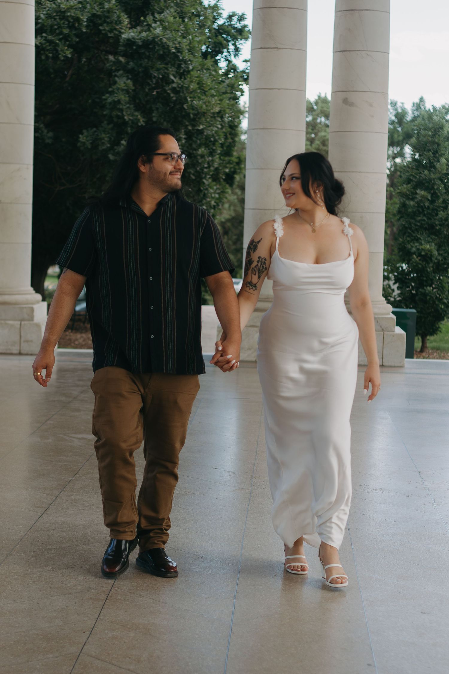 Artistic photo sequence showing couple walking between white columns with contrasting black and white attire.