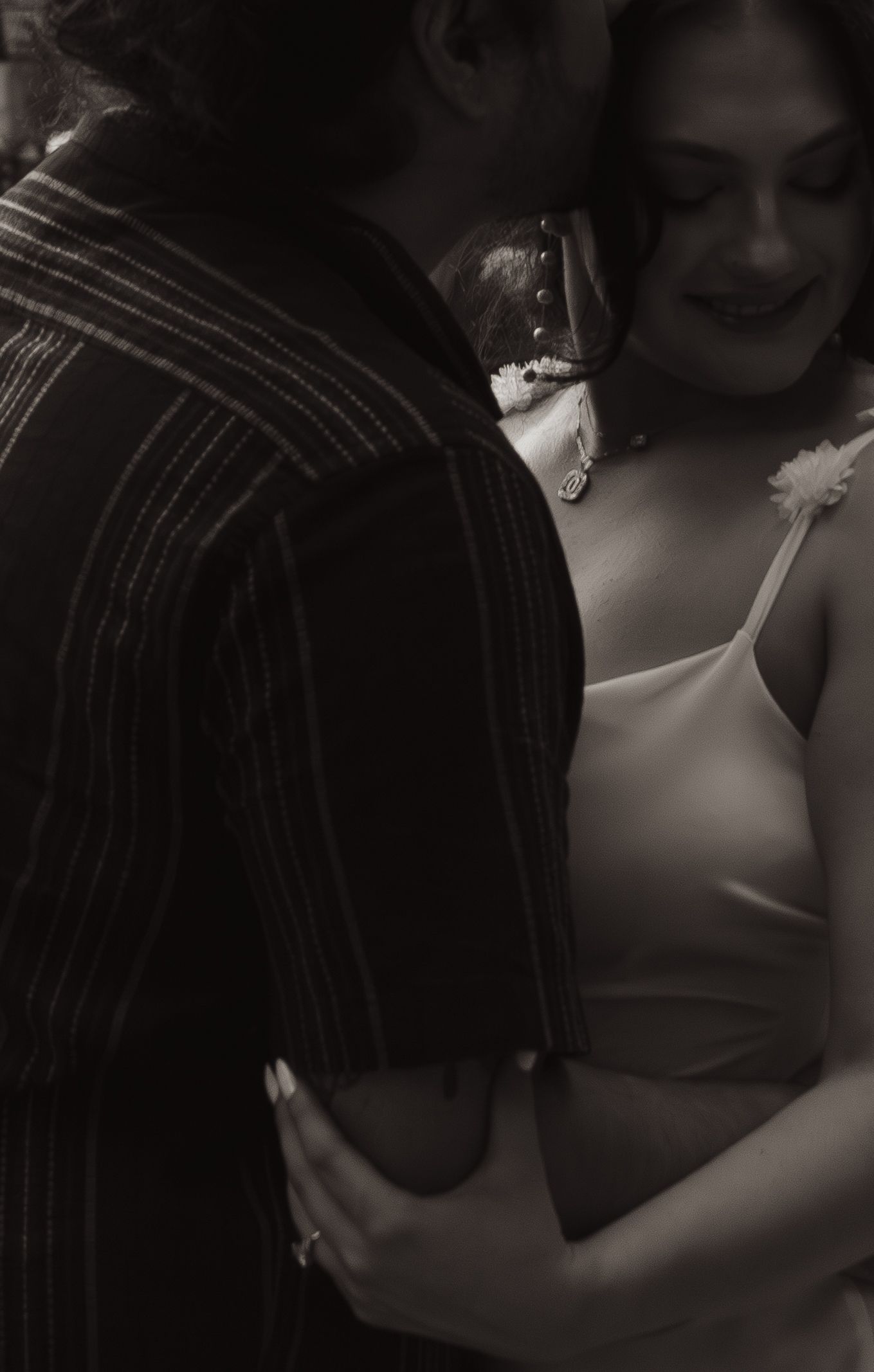 An atmospheric black and white photo of a romantic moment in an intimate setting.