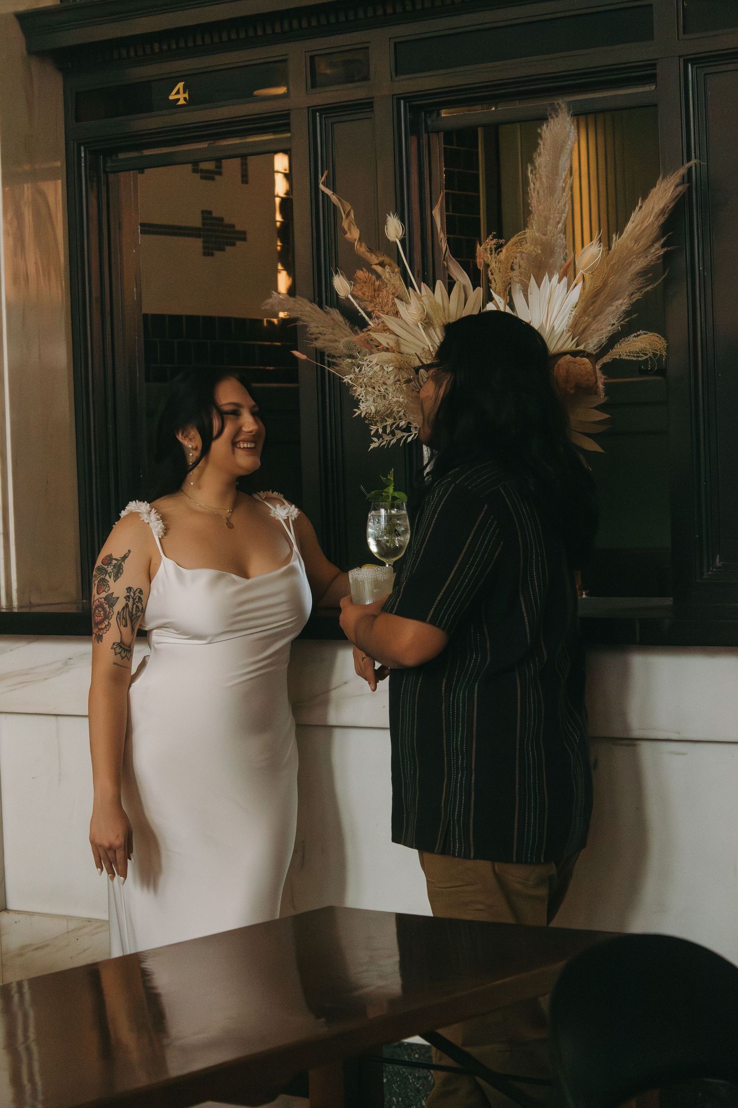 A couple sharing an intimate moment in a vintage hallway with wood paneling.