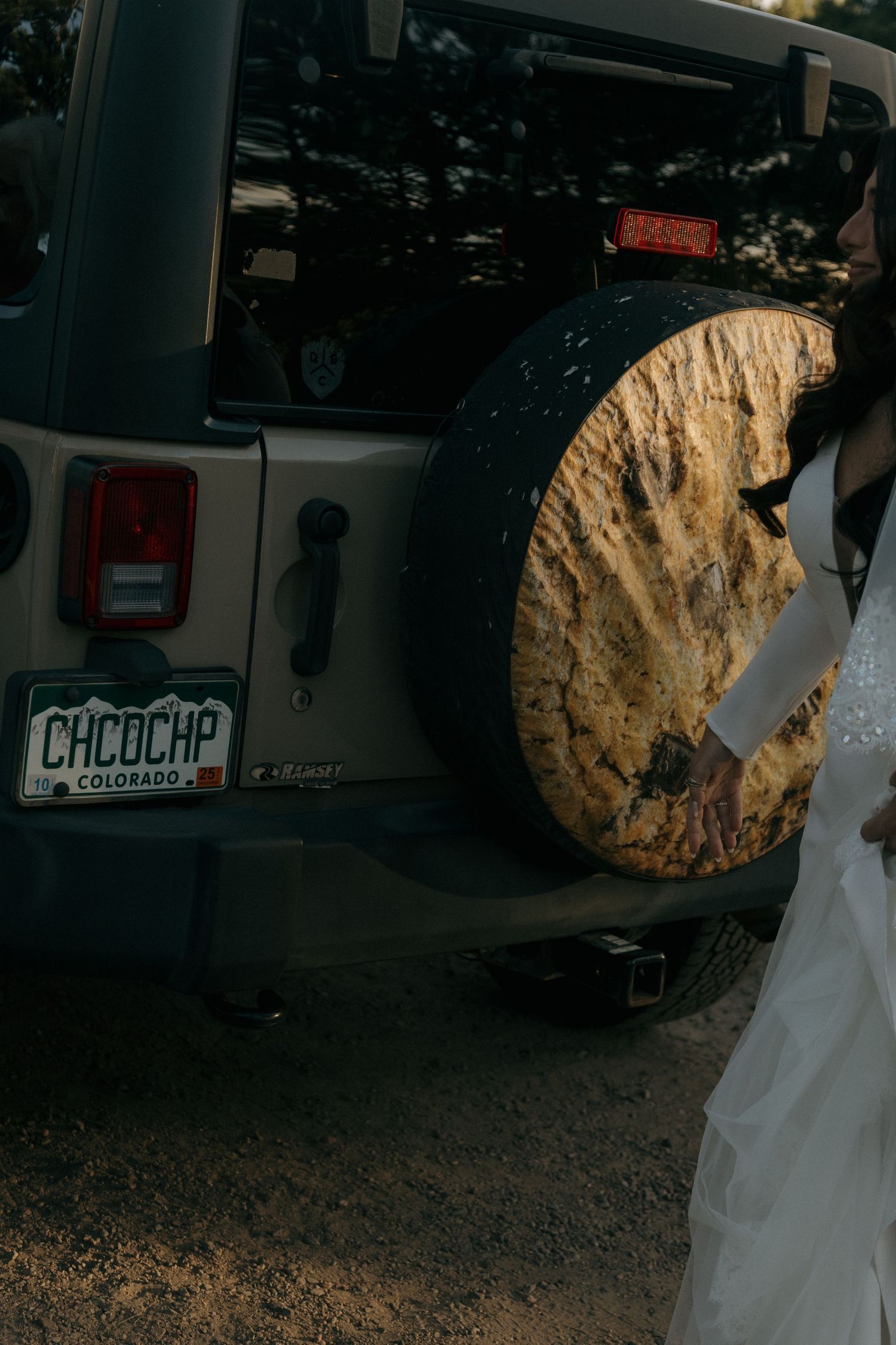 Colorado Jeep Wrangler with CHCOCHP license plate and scenic spare tire cover at a mountain wedding.