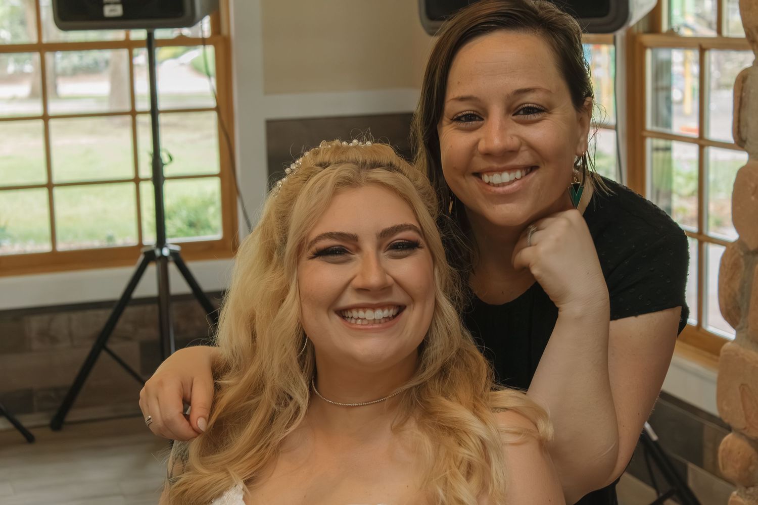 Candid moments of joy and laughter captured during wedding preparations indoors.