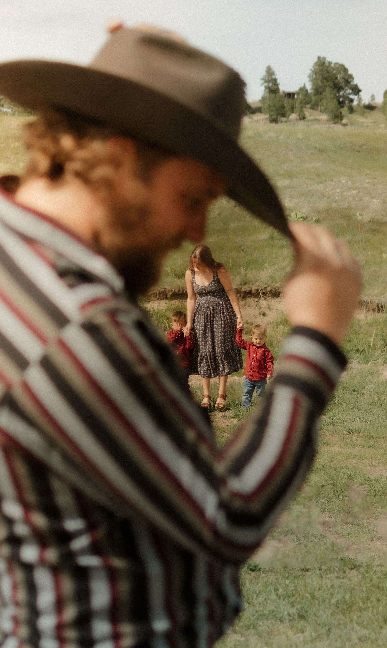 Multiple frames showing a person in a striped shirt and cowboy hat in a rural setting.