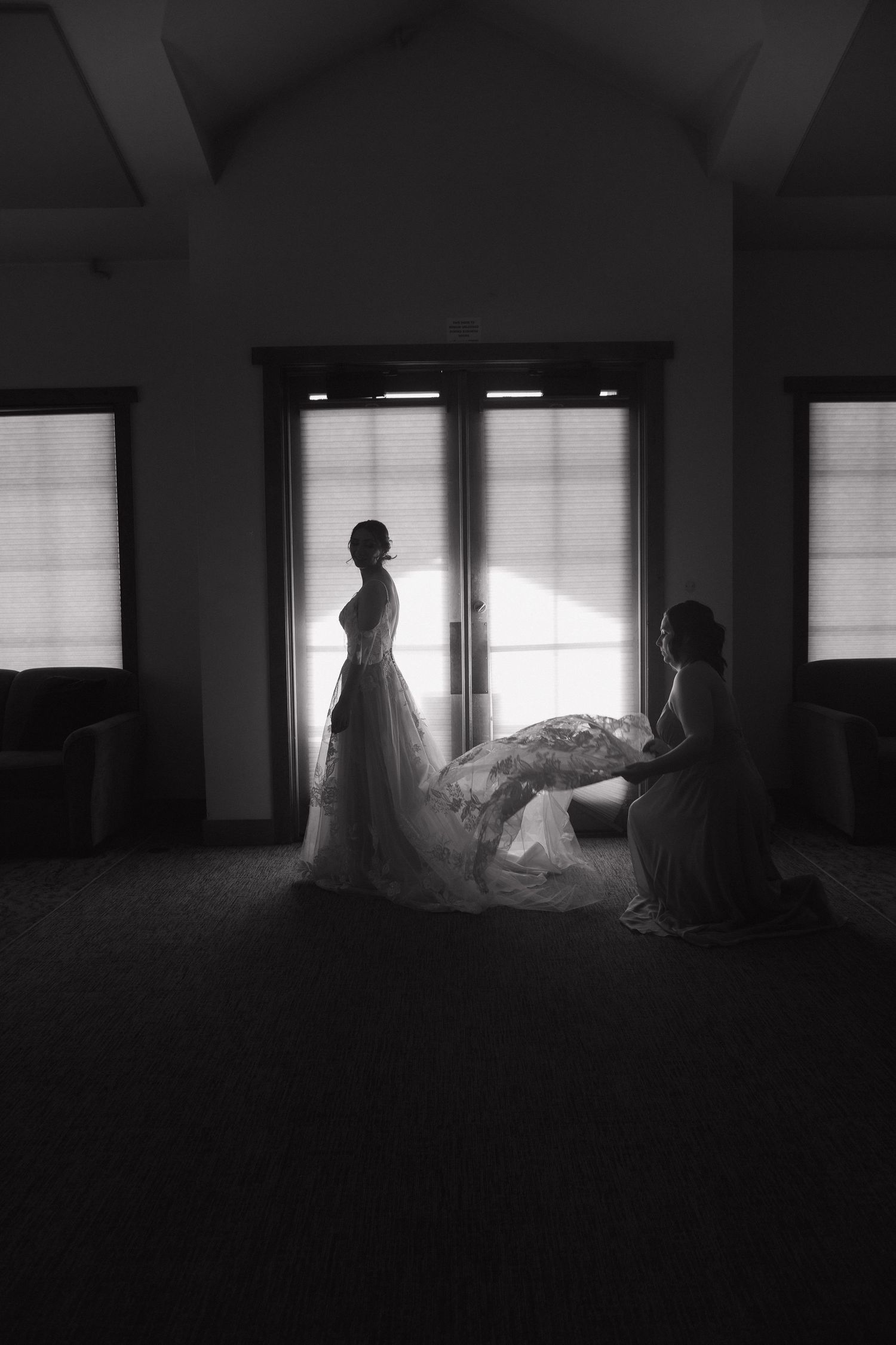 Dark silhouettes against windows create a moody panoramic sequence of interior spaces in black and white photography.