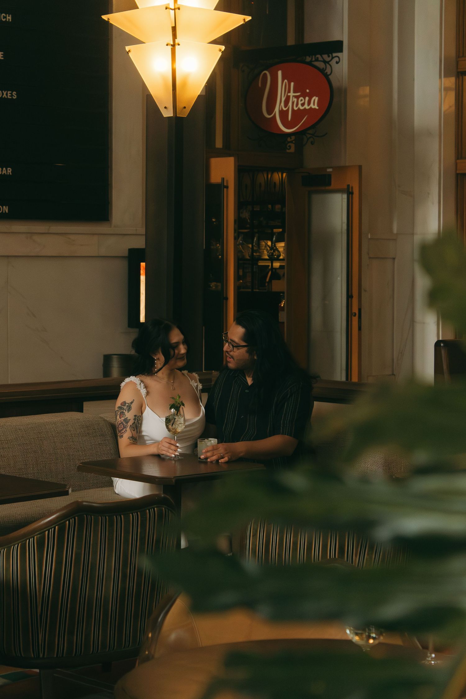 An intimate evening scene with soft lighting and outdoor seating at a restaurant.