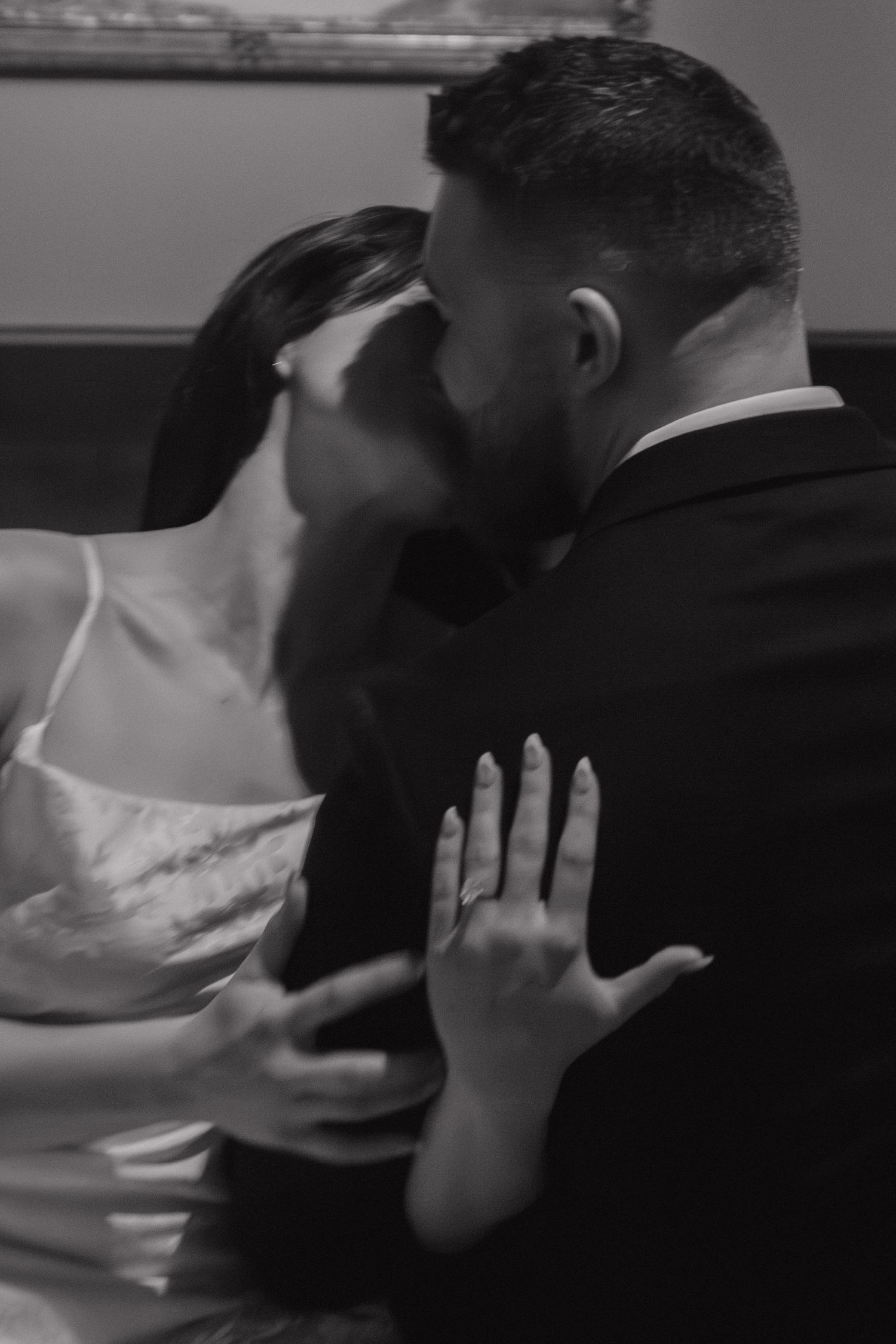 A romantic embrace captured in black and white photography.