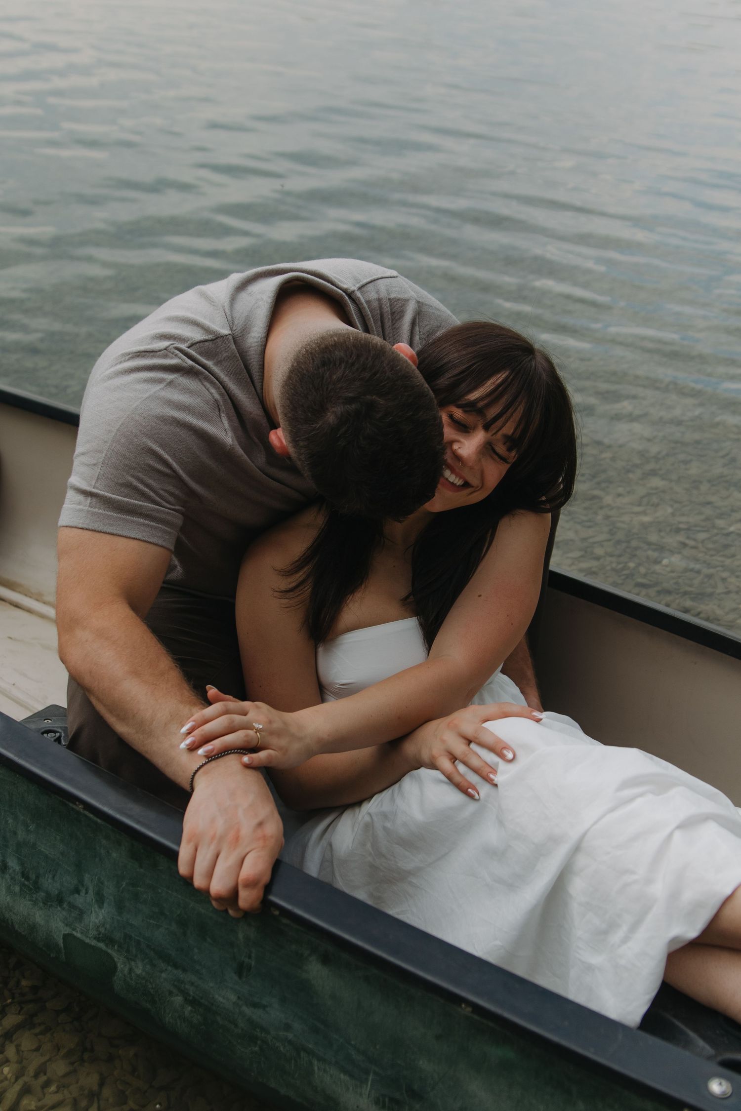 Intimate close-up of couple sharing a quiet moment together in a green canoe.